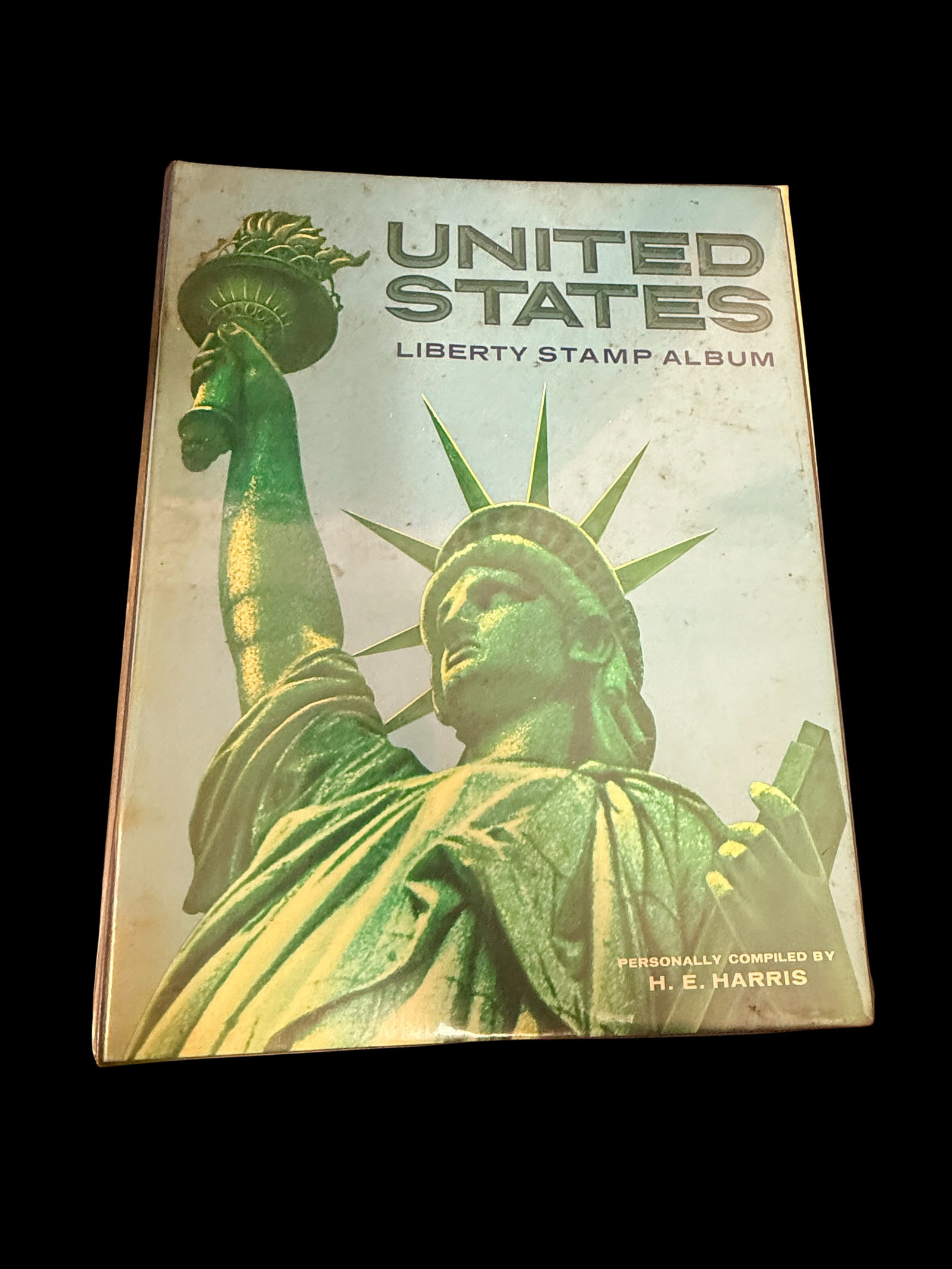 Vintage HE Harris United States Liberty Stamp Album: A vintage HE Harris United States Liberty stamp album measuring 6x5x2 inches. Harris stamp albums are the recognized standard for American philatelists, and a filled album can command significant coll
