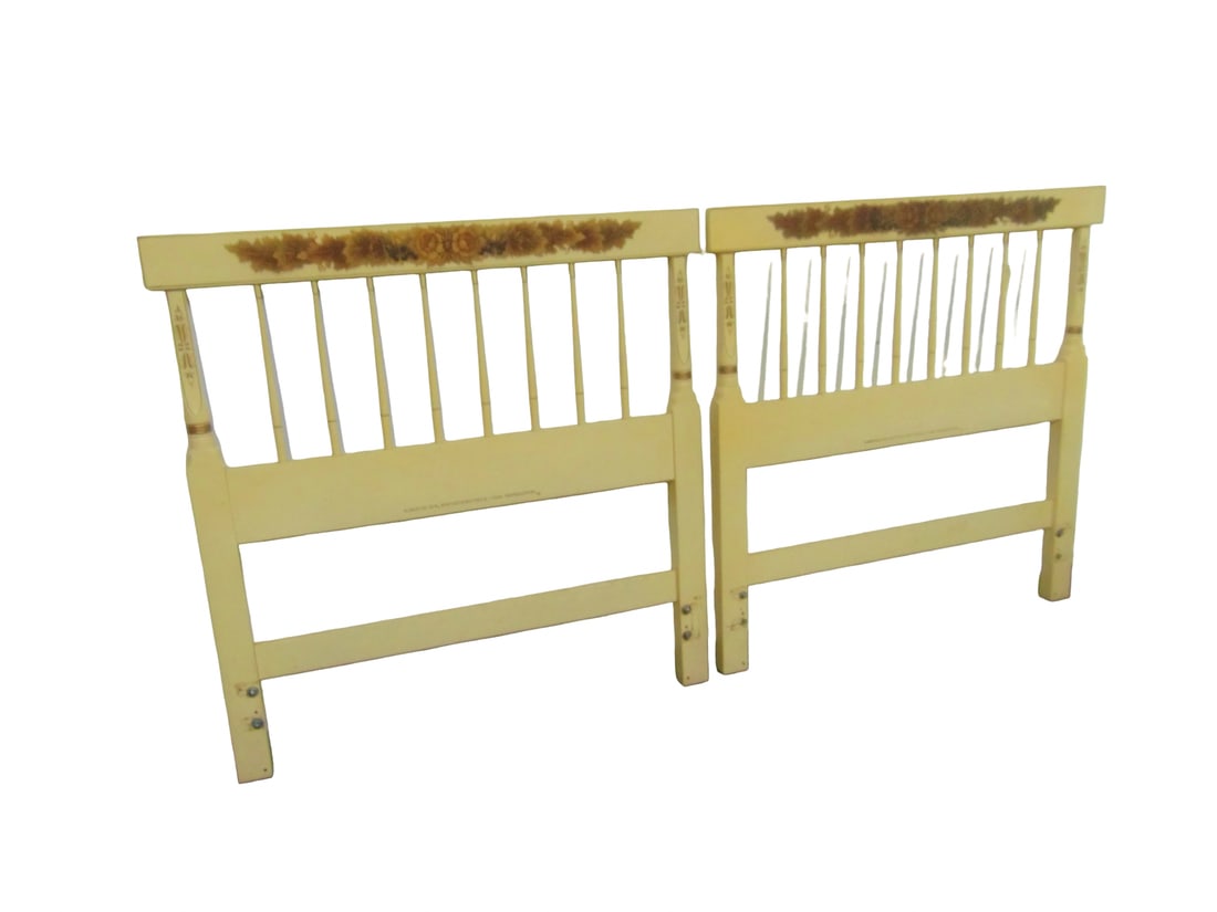 Pair of Vintage Hitchcock twin-size headboards featuring a cream-painted finish and gold stenciled: Pair of vintage twin-size headboards by L. Hitchcock features a classic cream-painted finish adorned with the brand's iconic gold-stenciled floral harvest decoration.