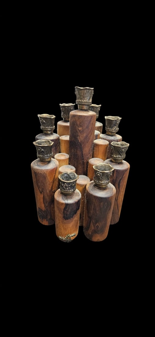 Vintage Siam Mixed Media Wood & Metal Sc: This unique decorative cluster features nine turned wood cylinders topped with ornate bronze-tone metal floral cups. The wood displays a rich, marbled grain pattern and the metal elements are stamped 