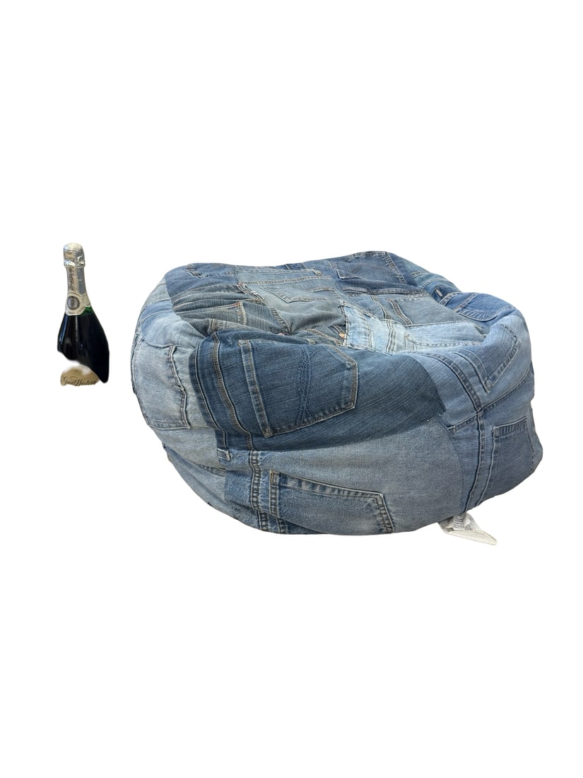 Recycled Patchwork Denim Bean Bag Chair: This unique bean bag chair features a patchwork exterior constructed from various recycled blue denim jeans. The design incorporates functional pockets, belt loops, and authentic branding patches incl