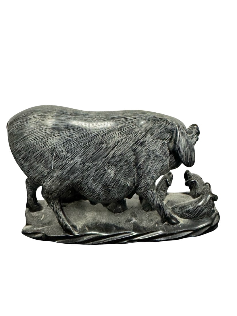 Stone Carved Sow and Piglets Sculpture: A hand-carved stone sculpture depicting a sow nursing her piglets on a naturalistic rocky base. The piece features a dark, possibly soapstone or similar soft stone, with finely incised lines detailing