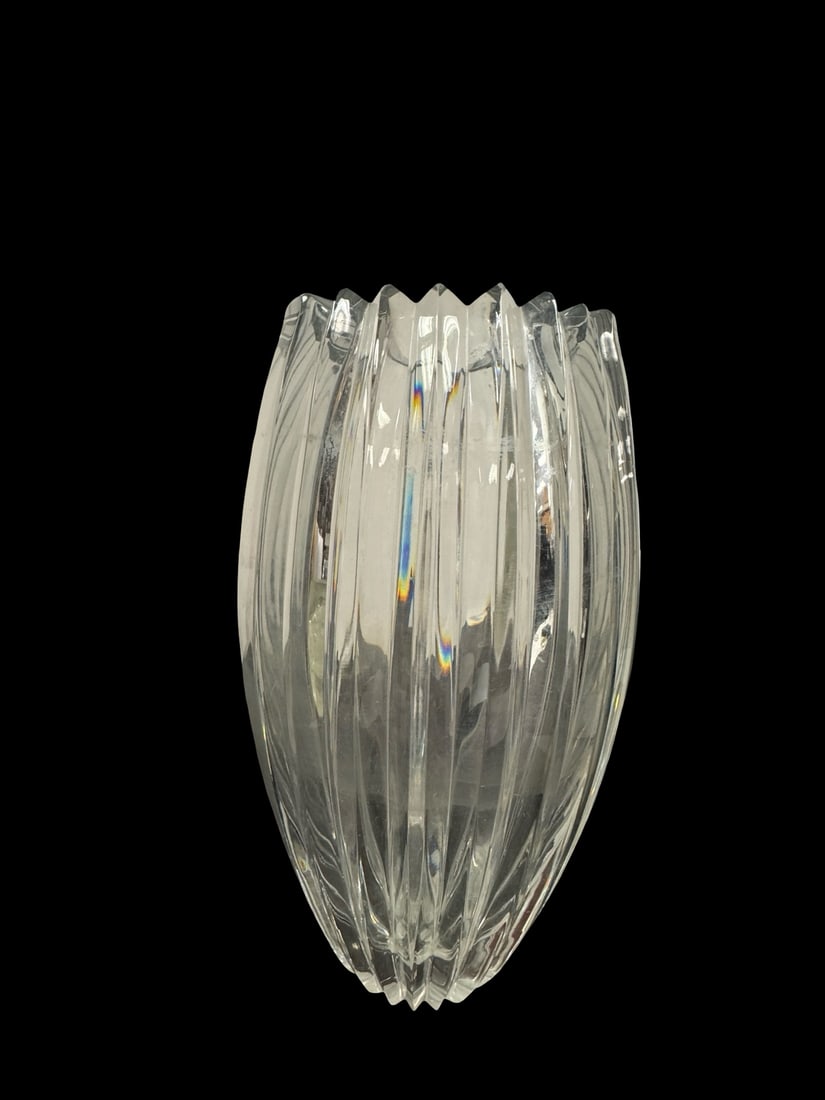 Large Ribbed Clear Glass Tapered Vase: This large clear glass vase features a heavy, tapered body with deep vertical ribbing that creates a sawtooth rim. The thick-walled construction provides significant weight and stability for large flo