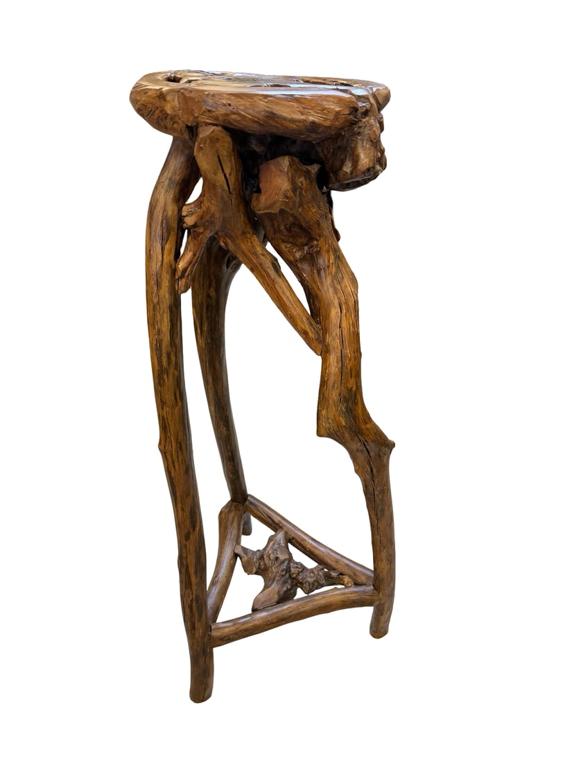 Organic Root Wood or Driftwood Pedestal: This unique pedestal stand is crafted from natural driftwood or root wood, featuring an organic many-legged base that tapers to a triangular stretcher. The circular top is composed of cross-sections
