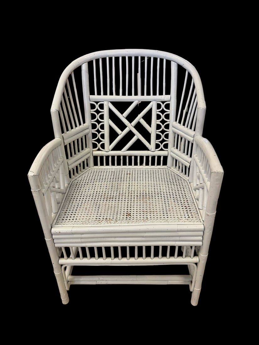 1970’s Vintage Rattan Barrel Back Chair: This white-painted rattan armchair features a distinctive barrel back design with a tall spindled crest. The frame is accented with geometric lattice work on the back and sides over a classic woven ca