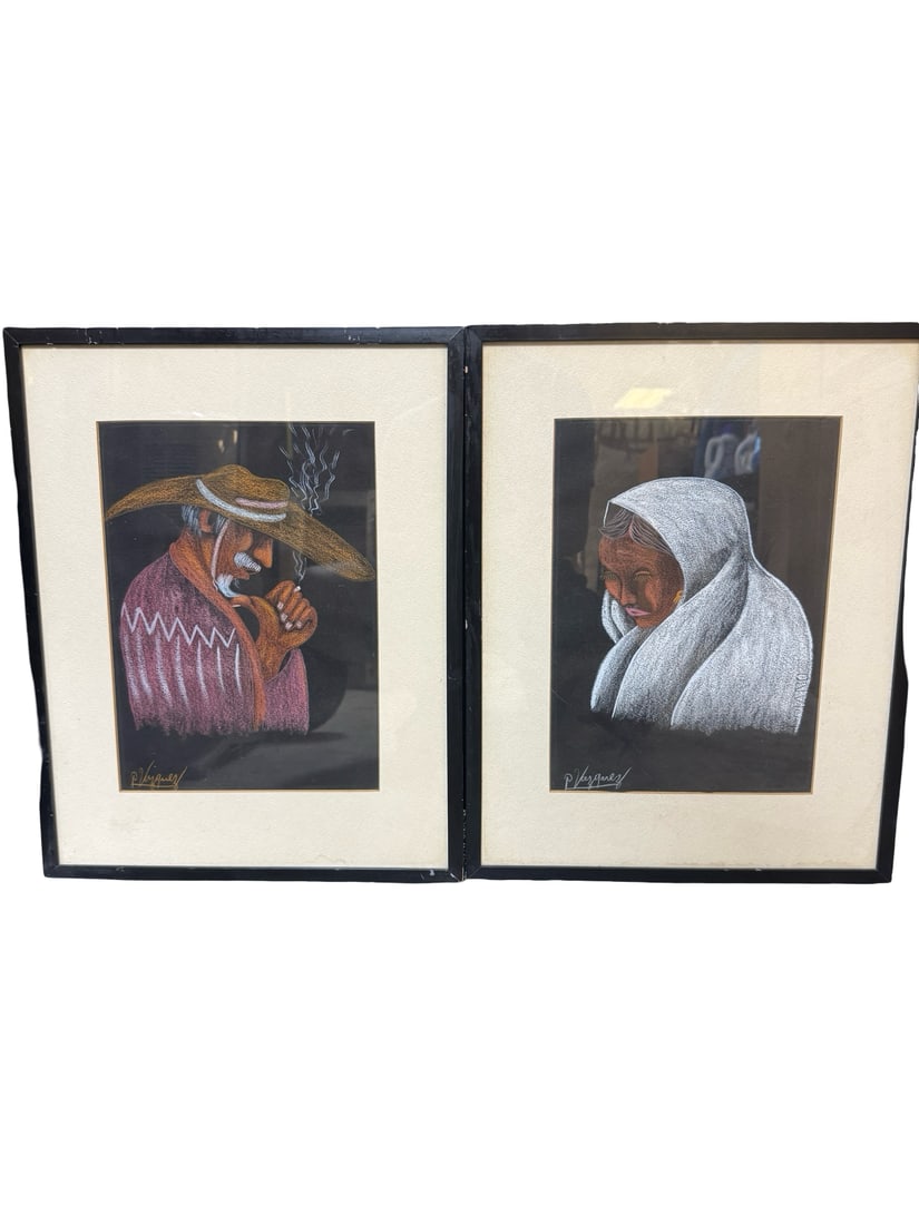 Pair of Framed Portraits Sgd P. Vazquez: This pair of framed artworks features charcoal and pastel portraits of a man in a wide-brimmed hat and a woman in a white shawl, depicted in a stylized indigenous manner. Each piece is rendered on dar