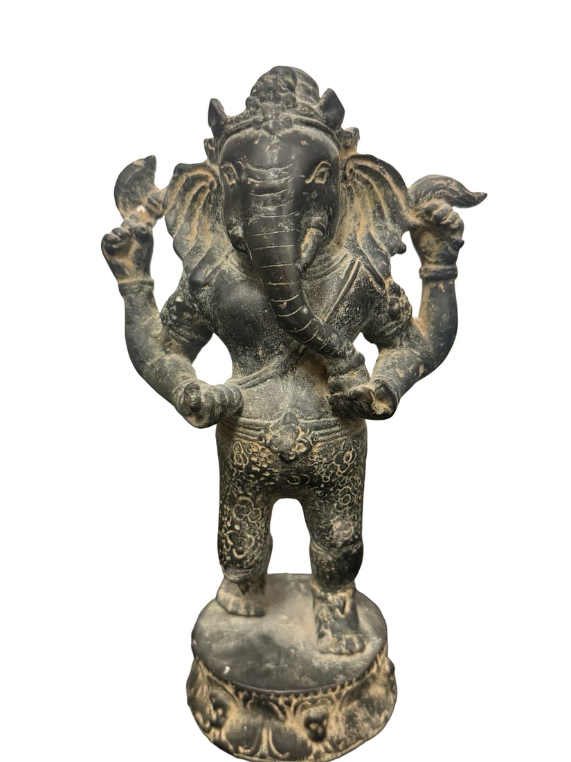 Vintage Weathered Cast Metal Ganesha Sta: An aged cast metal statue depicting the Hindu deity Ganesha standing atop a circular lotus-motif base. The figure features four arms holding traditional symbolic attributes and is finished in a dark,