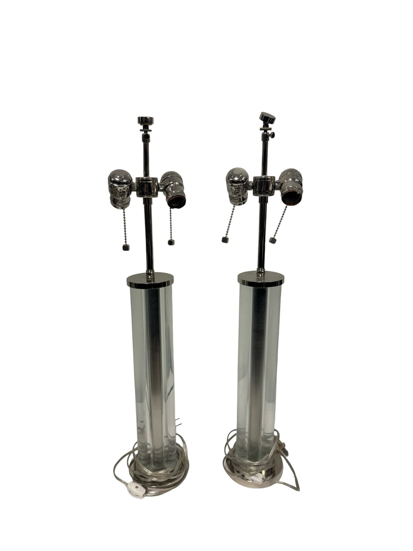 Pair of Modern Glass & Chrome Lamps: This pair of contemporary table lamps features a sleek design with solid clear glass columnar bases. Each lamp is topped with a chrome-finished double socket cluster featuring individual pull-chain