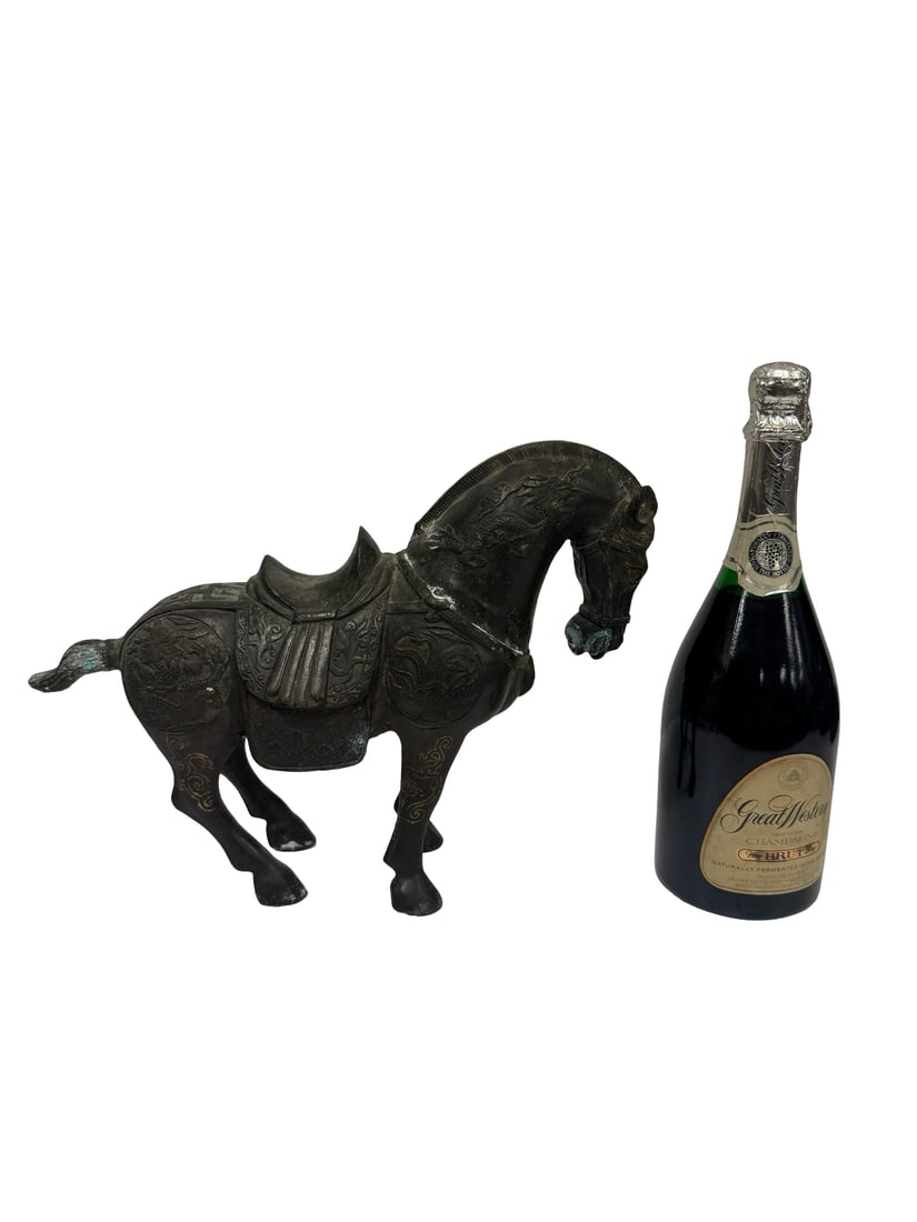 Chinese Style Cast Metal War Horse: Large cast metal horse figure featuring an ornate saddle and decorative dragon motifs on the haunches. The piece is finished in a dark patina and includes a four-character mark on the saddle seat. Thi
