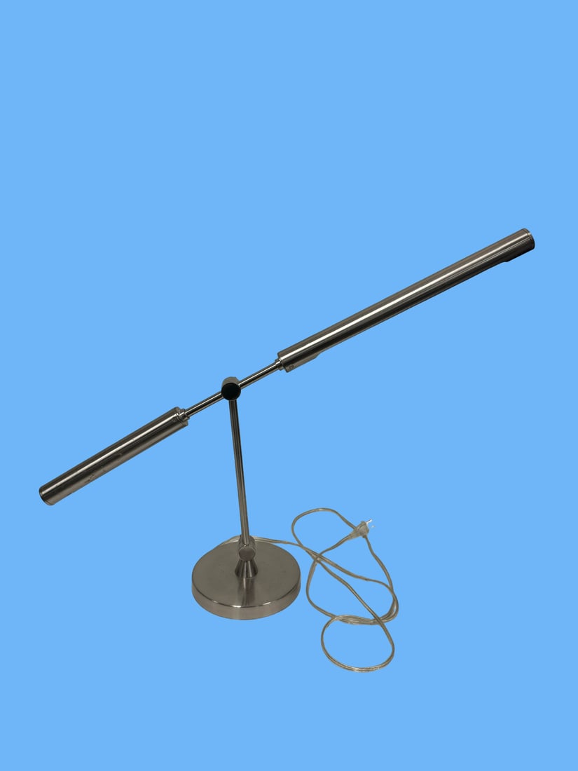 Modern Brushed Metal Adjustable Desk Lam: This modern minimalist desk lamp features a sleek brushed metal finish and a distinctive pivoting T-bar design. The articulated arm and rotating head allow for precise light positioning over a