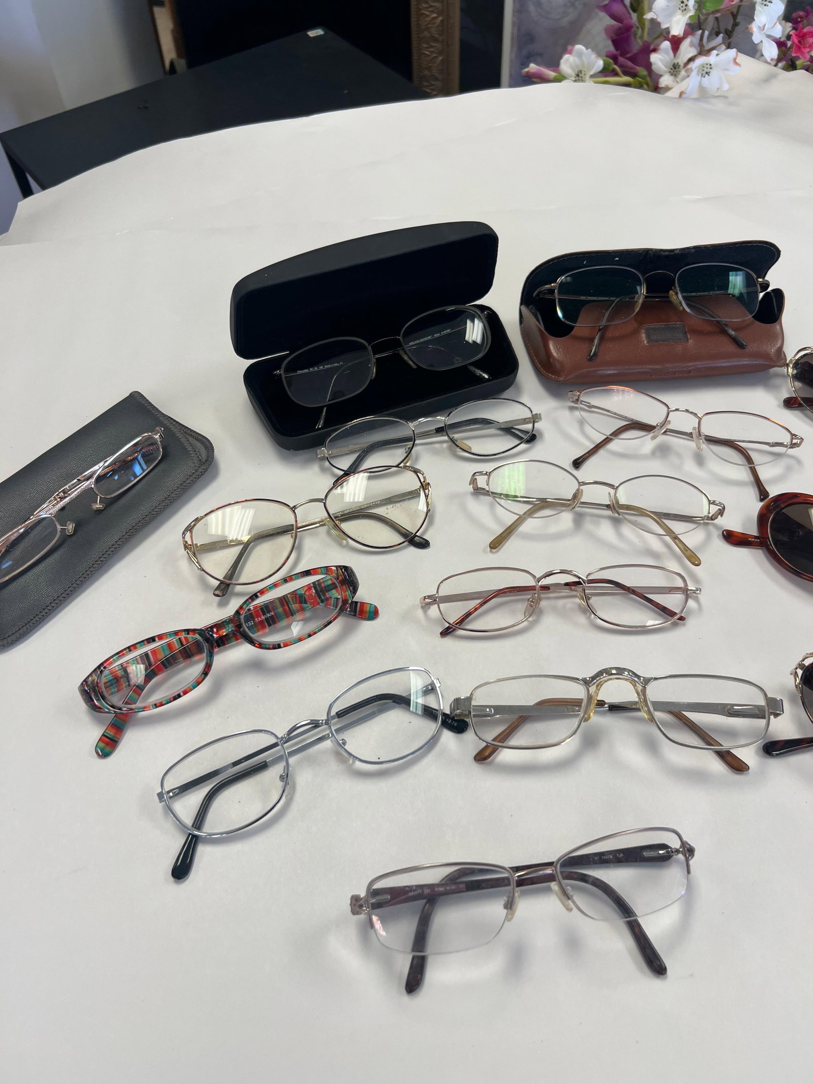 Large Assorted Eyewear & Cases Lot: A diverse collection of fifteen pairs of eyewear including both prescription-style frames and sunglasses. The lot features various frame materials such as metal and plastic in styles ranging from clas