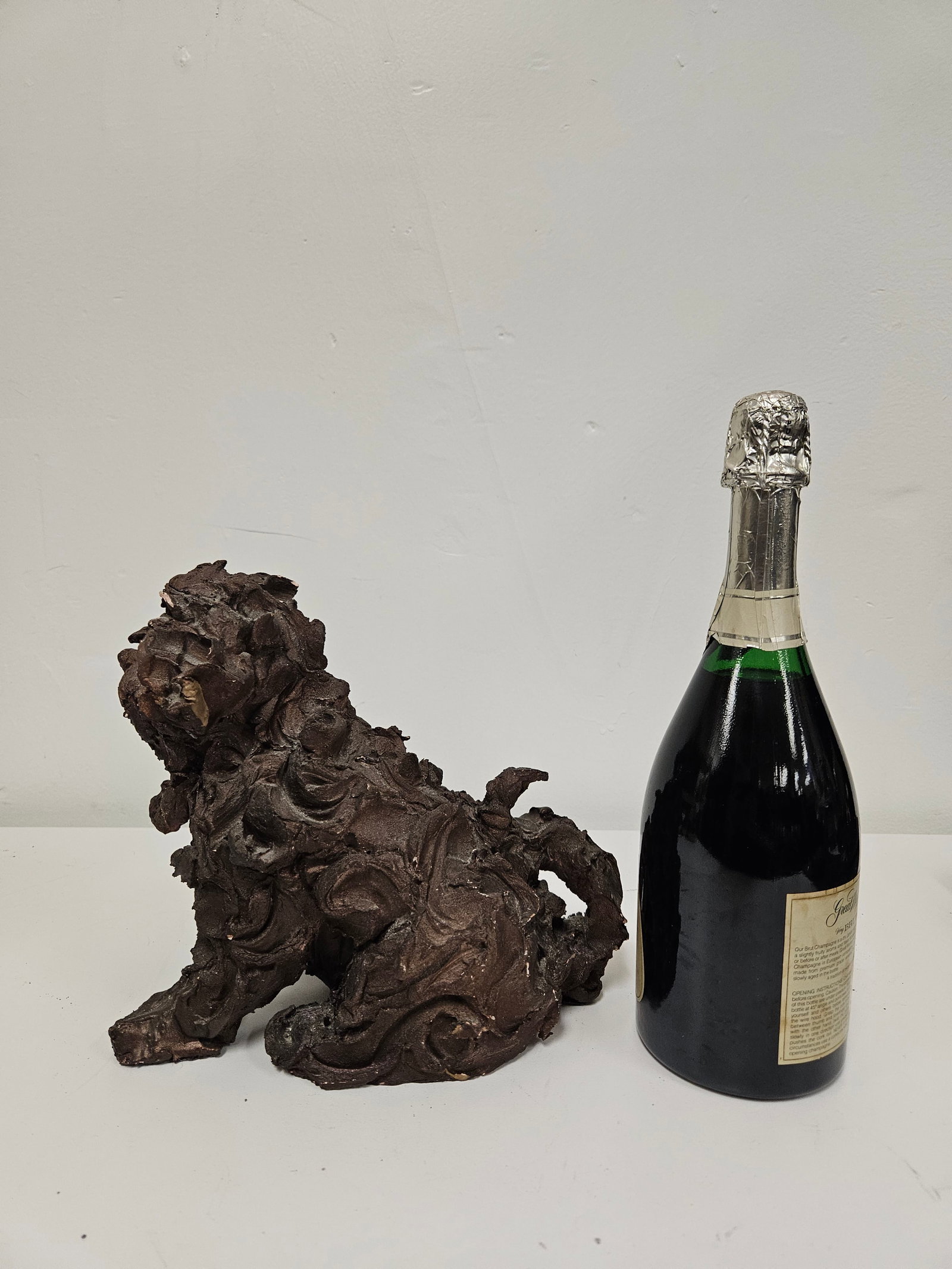 Modernist Impasto Style Poodle Sculpture: This expressive impasto-style sculpture depicts a poodle in a seated position with a heavily textured surface. The piece is finished in a dark bronzed-tone brown that accentuates the swirling, thick a