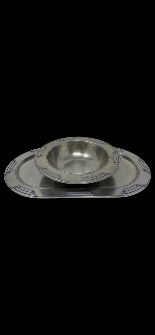 Wilton Mount Joy Pewter Tray and Bowl: This two-piece set features an oval tray and matching bowl made of sand-cast pewter by Wilton Mount Joy. Both pieces are decorated with an Art Deco inspired geometric pattern highlighted by blue ename