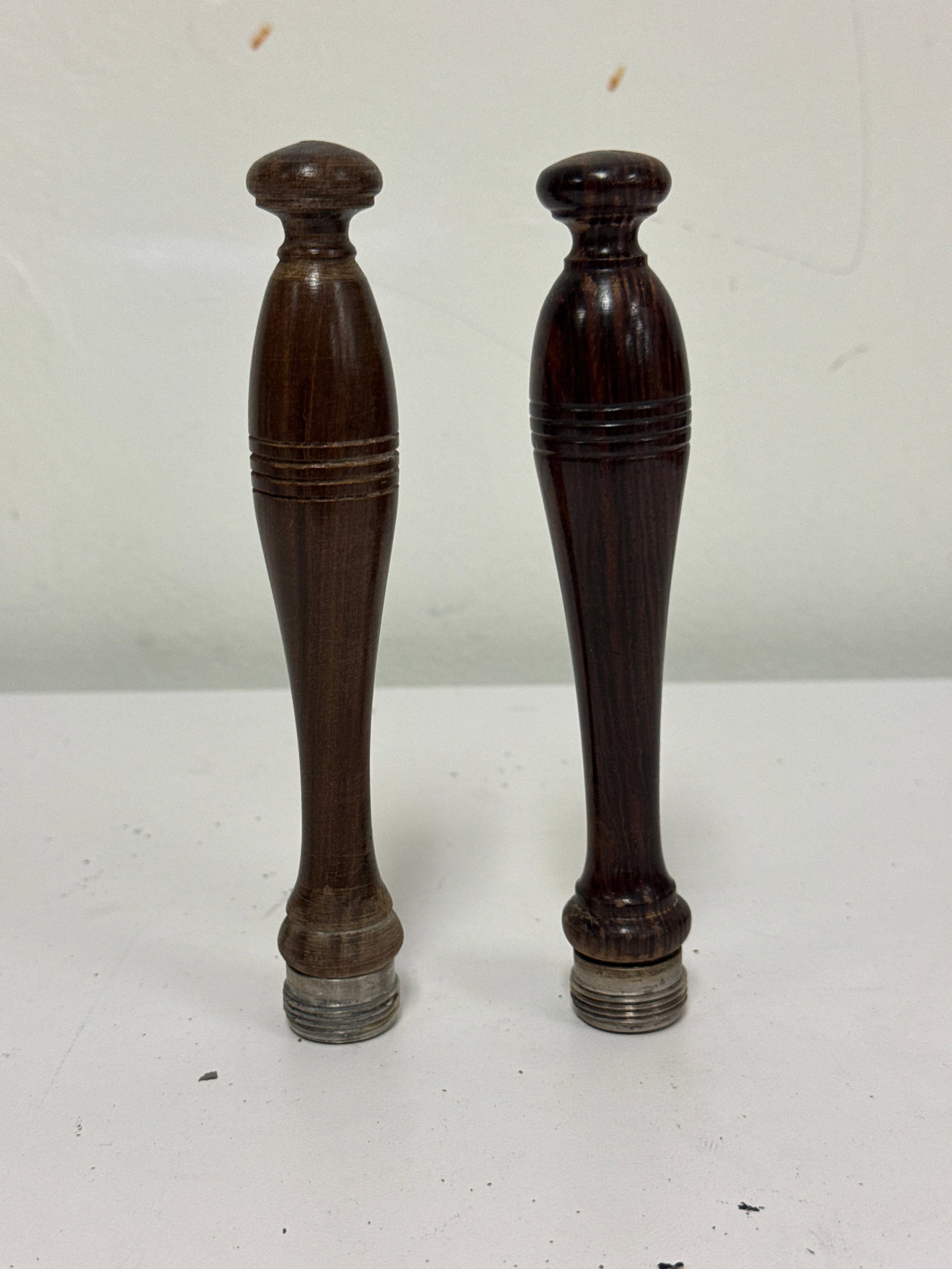 Pair of Antique Turned Wood Handles: This pair of turned wood handles features a classic baluster shape with decorative incised rings. Each piece is fitted with a threaded metal base, suggesting they were originally part of a larger arch