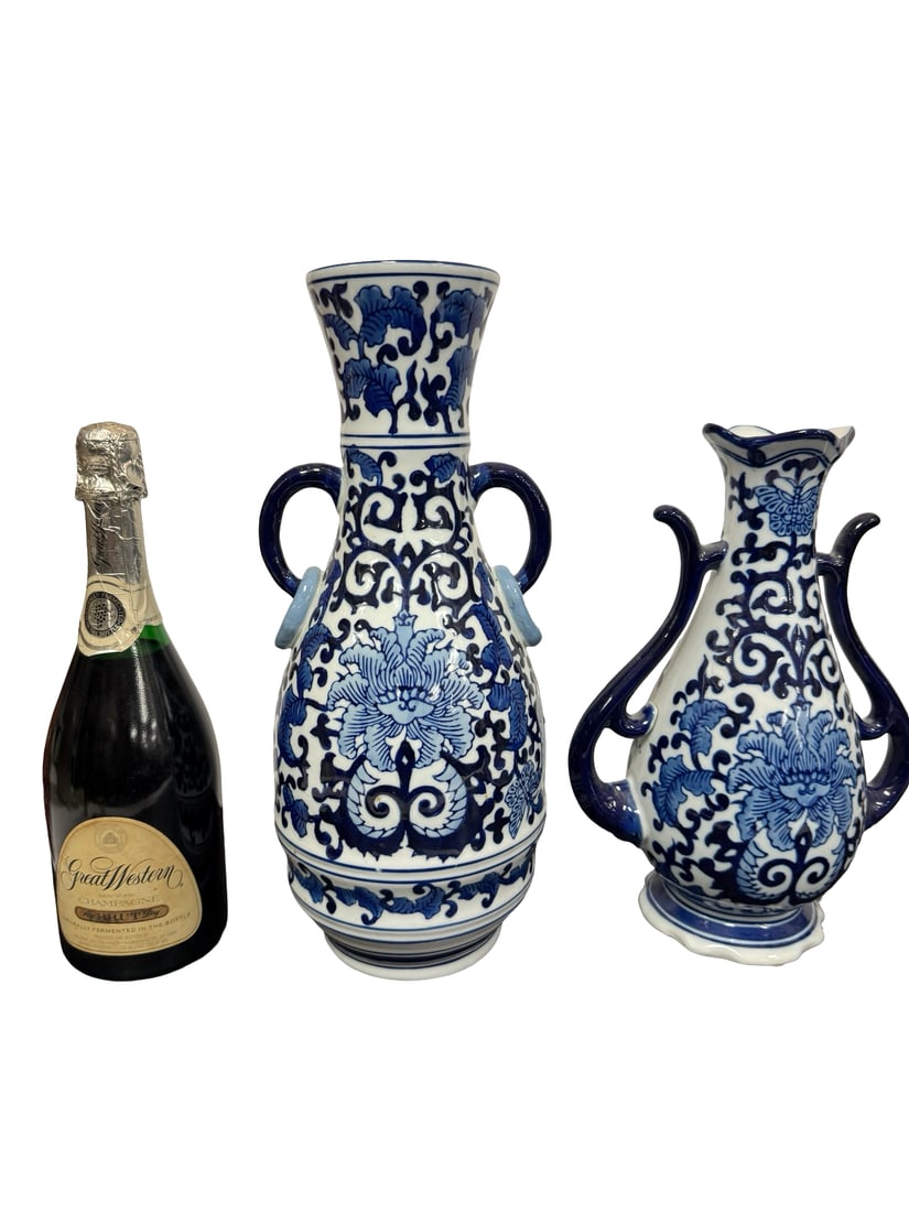 Pair of Seymour Mann China Blue Porcelai: A pair of decorative blue and white porcelain vases featuring traditional scrolled floral and foliate motifs. Each piece showcases stylized handles and a glazed finish in the classic Chinese export st