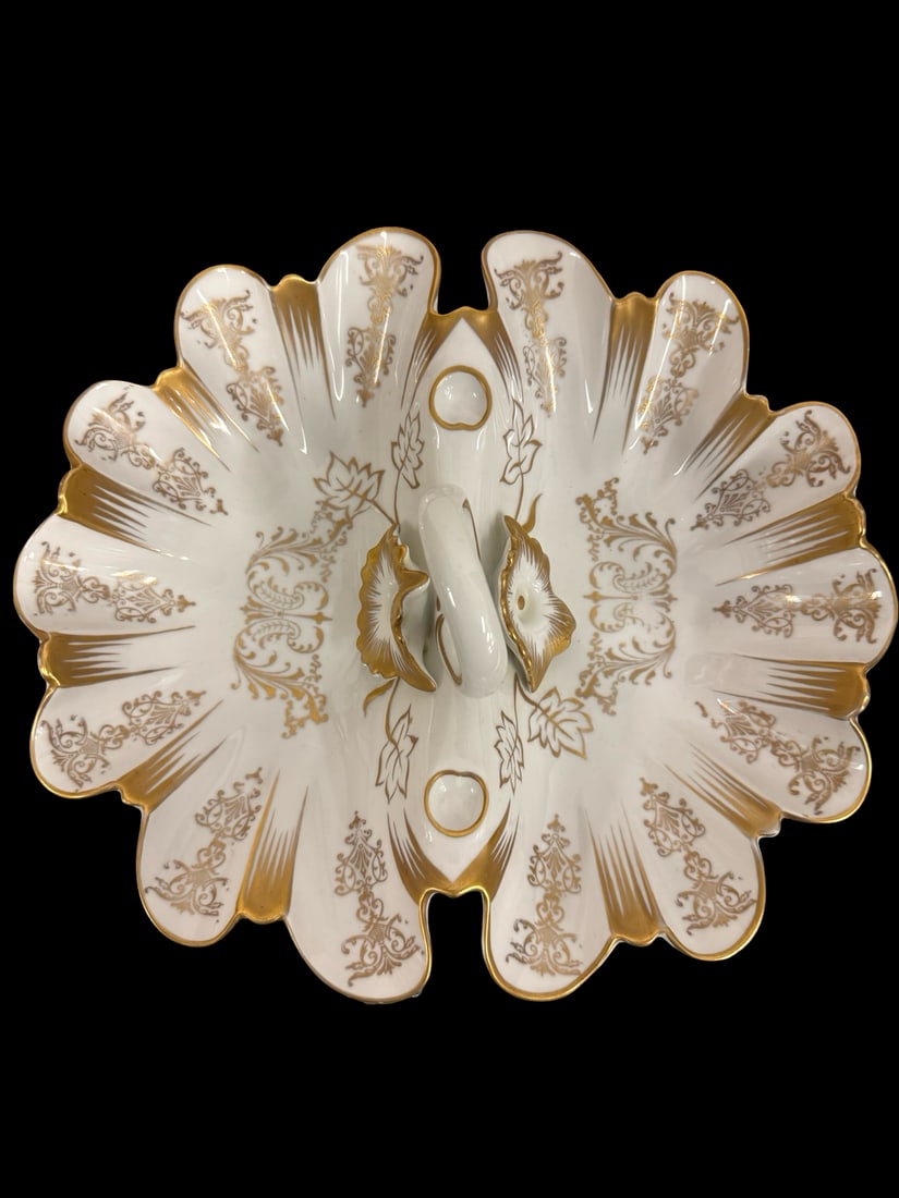 Vintage German Gilt Porcelain Divided Se: This elegant vintage porcelain divided dish features a scalloped edge and a central looped handle for easy serving. The piece is decorated with intricate gilt floral and scrollwork patterns over a cle