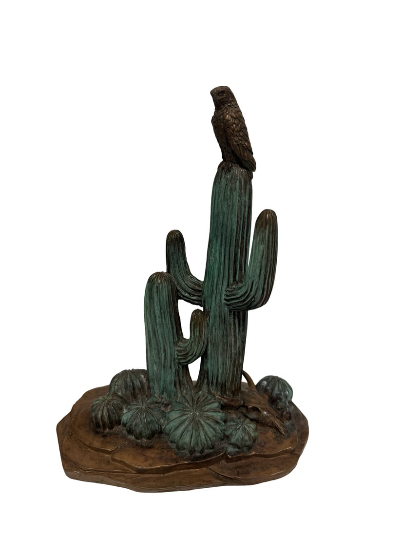 Vanderveen Signed Bronze Sculpture: This detailed bronze sculpture features a hawk perched atop a tall saguaro cactus, surrounded by small desert flora and a bovine skull at the base. The piece is finished with a striking verdigris pati