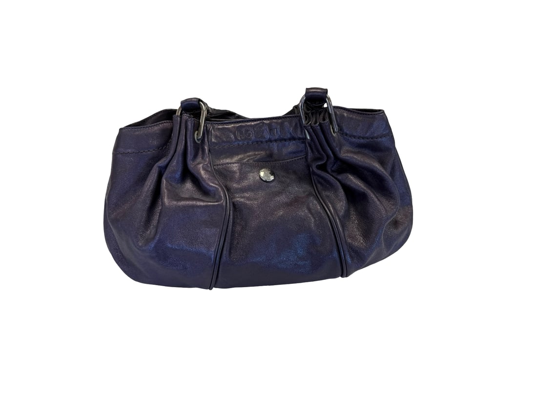 Italian Designer-Style Hogan Leather Bag: This stylish handbag features a soft, textured leather exterior in a deep purple or midnight blue hue. The design includes pleated details, a top carry handle, and silver-tone hardware including a