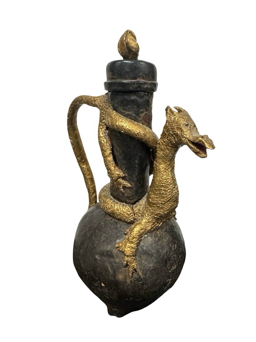 Ceramic Dragon Motif Vessel with Stopper: This unique ceramic vessel features a hand-sculpted dragon with a gold-toned textured finish wrapped around a dark cylindrical neck and bulbous base. The piece is designed with a high-arched handle an