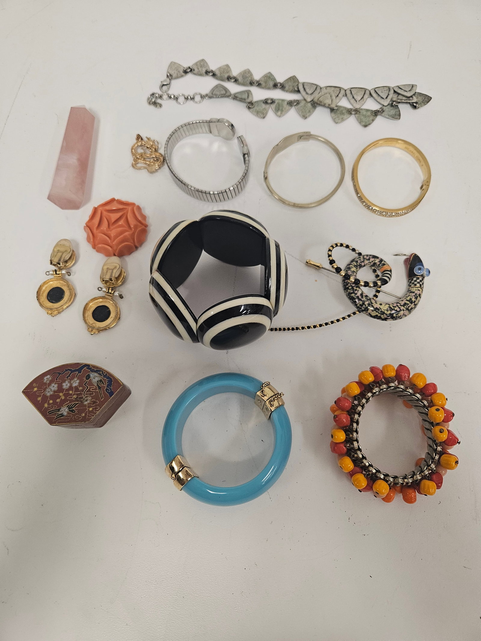 Eclectic Costume Jewelry & Accessory Lot: This eclectic assortment of costume jewelry includes a bold black and white striped resin bangle, a blue-tone hinged bracelet, and a vintage-style snake brooch. The lot also features several