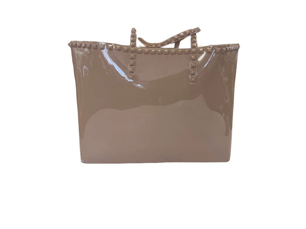 Taupe Studded PVC Jelly Tote Bag: This PVC tote bag in a taupe colorway features molded pyramid stud detailing along the trim and handles, reminiscent of the Rockstud line. The spacious open-top design is constructed from a glossy, du