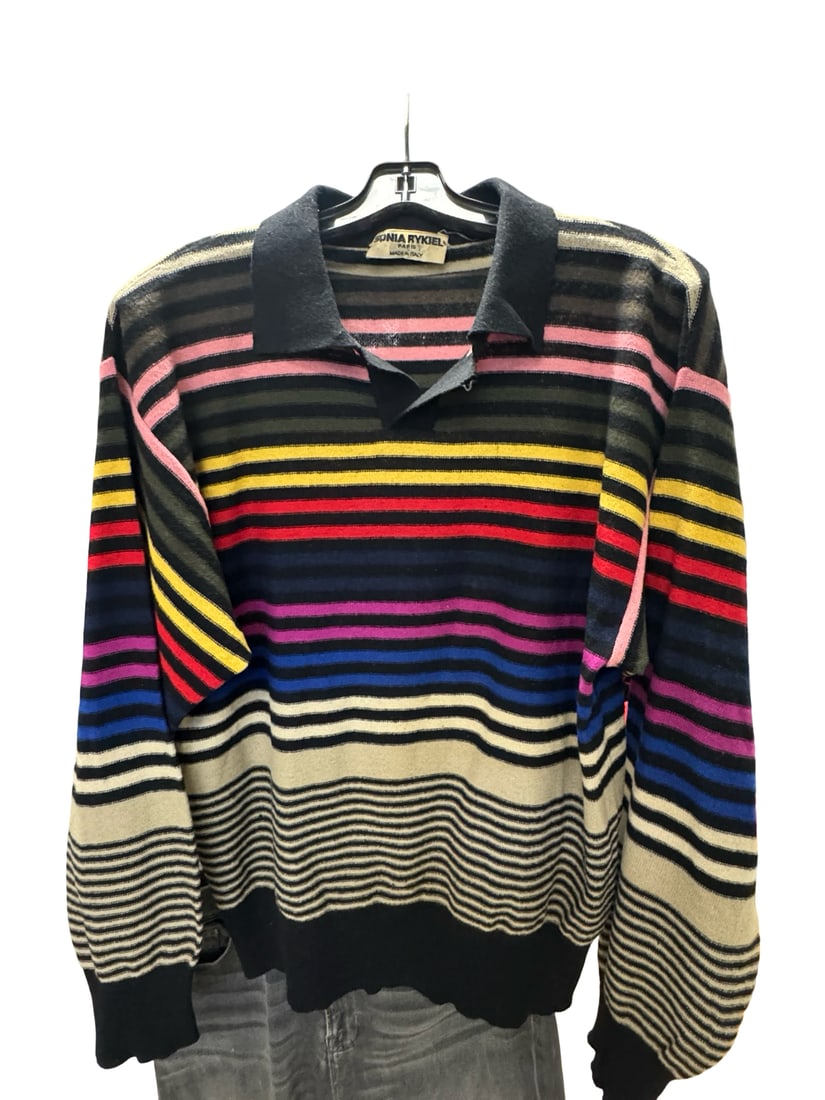 Vintage Sonia Rykiel Striped Knit Polo: This vibrant knit sweater features a multi-colored horizontal stripe pattern in pink, yellow, red, and blue tones. It is designed with a classic black polo-style collar and ribbed cuffs and hem. The
