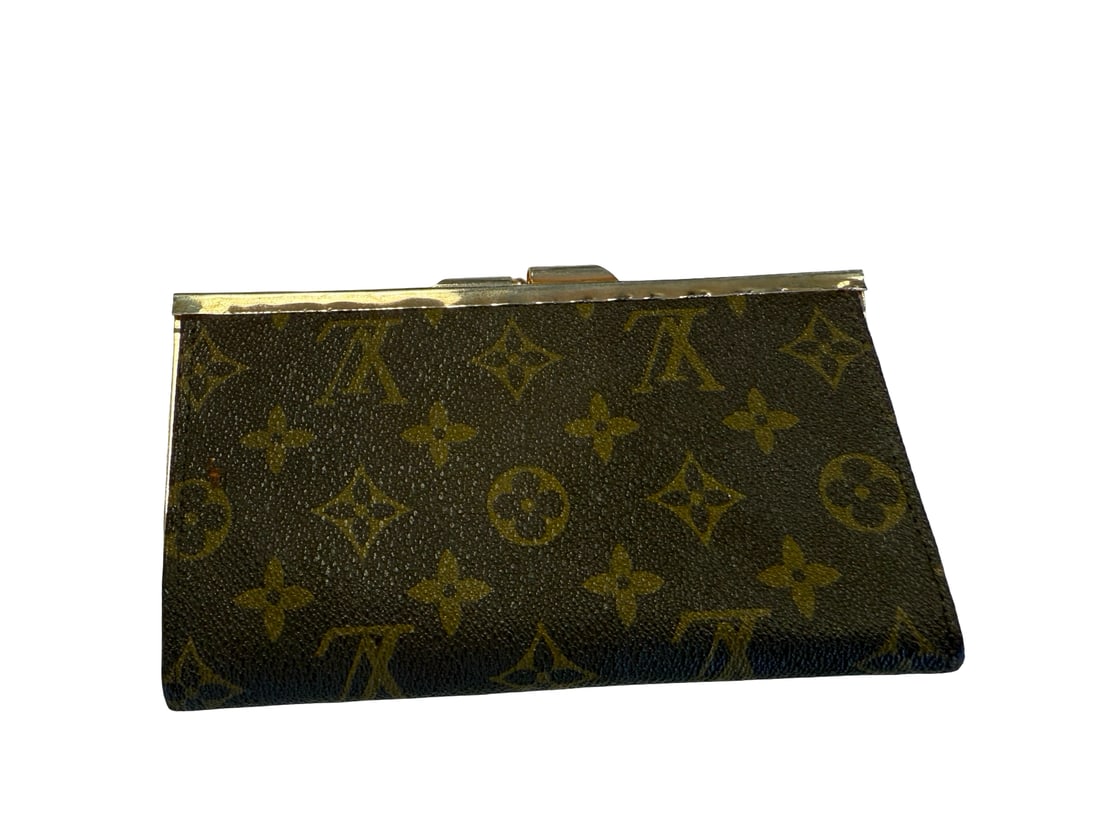 Louis Vuitton Monogram Style Wallet: This vintage-style kiss-lock wallet features a classic monogram pattern on coated canvas. The compact design is finished with a gold-tone metal frame and a traditional clasp closure. The interior reve