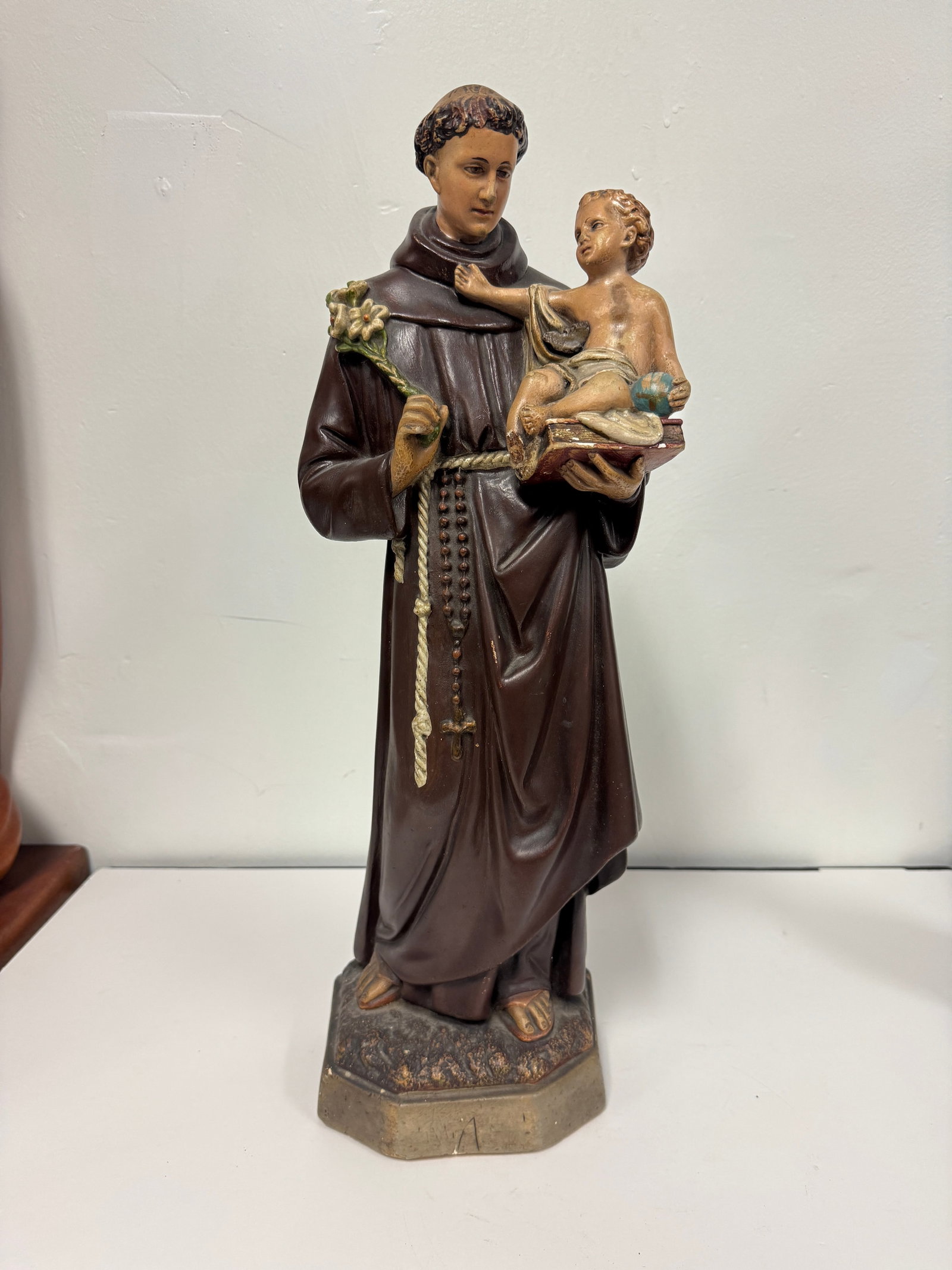 Vintage St. Anthony of Padua Statue: A polychrome painted religious statue depicting Saint Anthony of Padua holding the Christ Child. The figure is modeled in traditional monastic robes with a rosary and lilies, resting on a pedestal