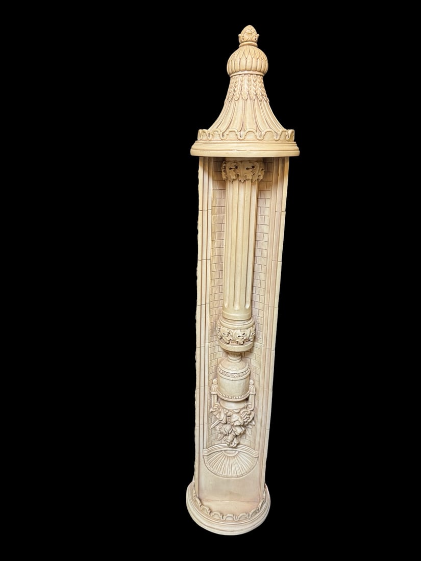 Neoclassical Style Relief Column Decor: This neoclassical style architectural column features intricate relief carvings of floral swags and a central urn against a brick-patterned backdrop. The piece is topped with a decorative finial and f