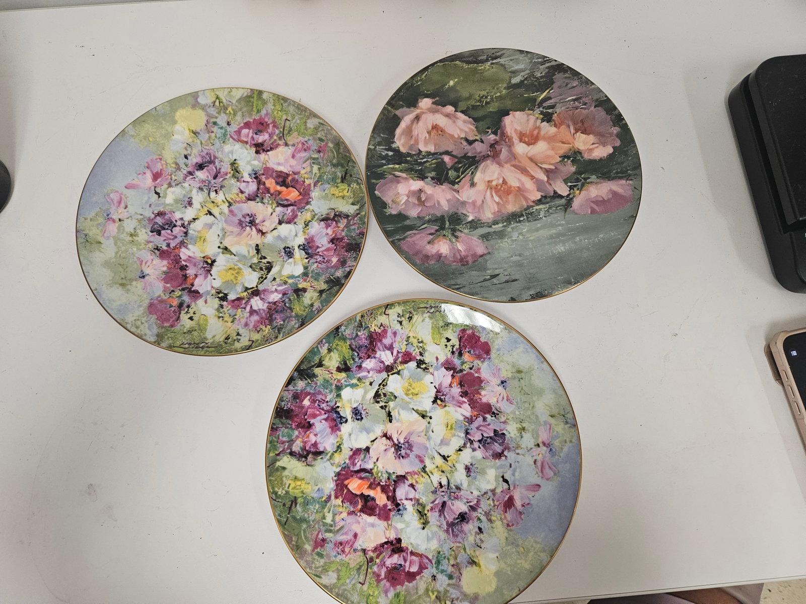 3 Royal Doulton Hahn Vidal Floral Plates: This lot features three fine bone china collector plates featuring impressionist floral artwork after original works by Hahn Vidal. The set includes two plates titled 'Spring Harmony' from 1975 and on