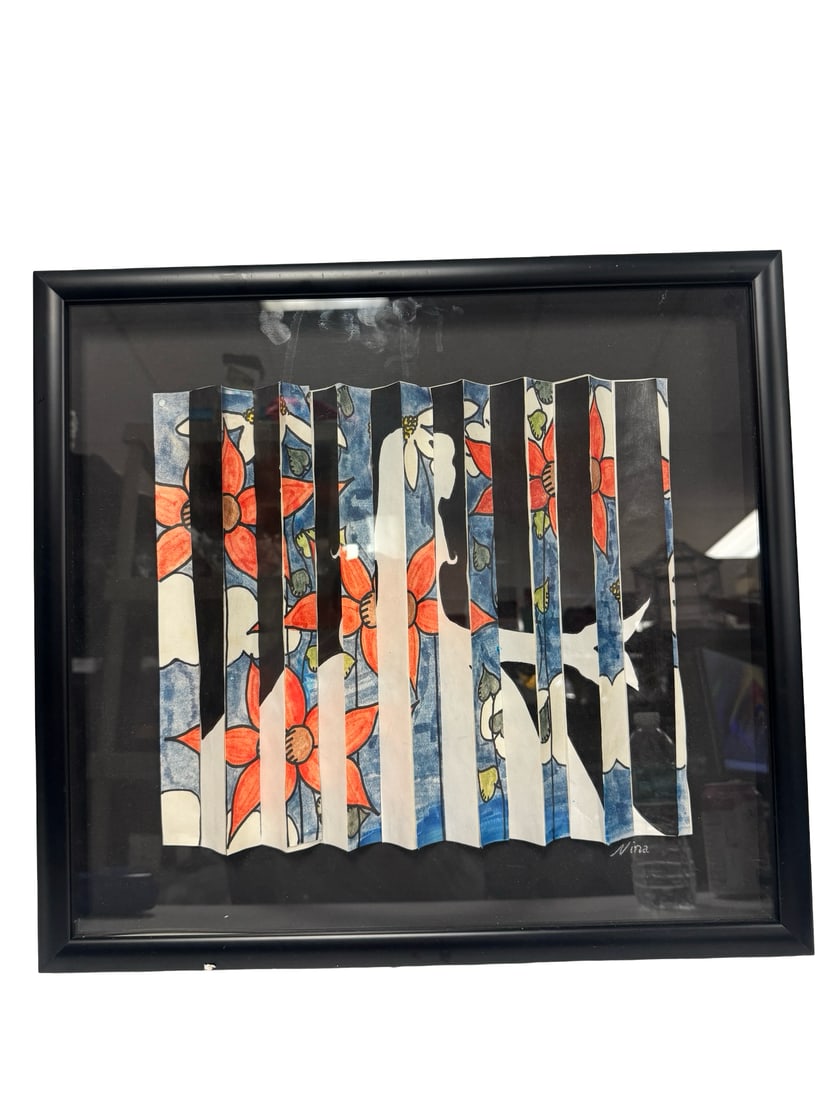 Nina Signed Pleated Paper Kinetic Art: This contemporary kinetic-style artwork features a pleated paper construction that creates a shifting image of floral patterns and a female silhouette. The piece is signed 'Nina' in the lower right co