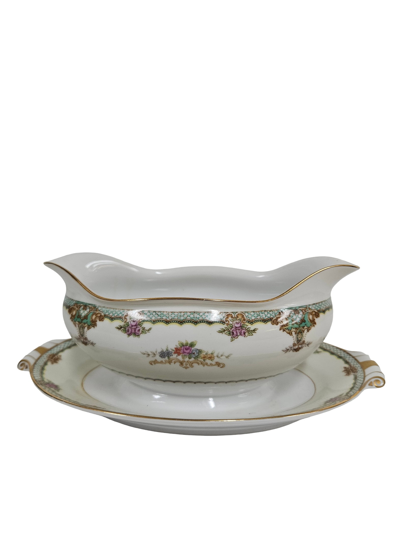 Vintage Porcelain Floral Gravy Boat: This vintage porcelain gravy boat features an attached underplate and is decorated with ornate floral swags and a turquoise scale-pattern border. The design is accented by delicate gilt edges and