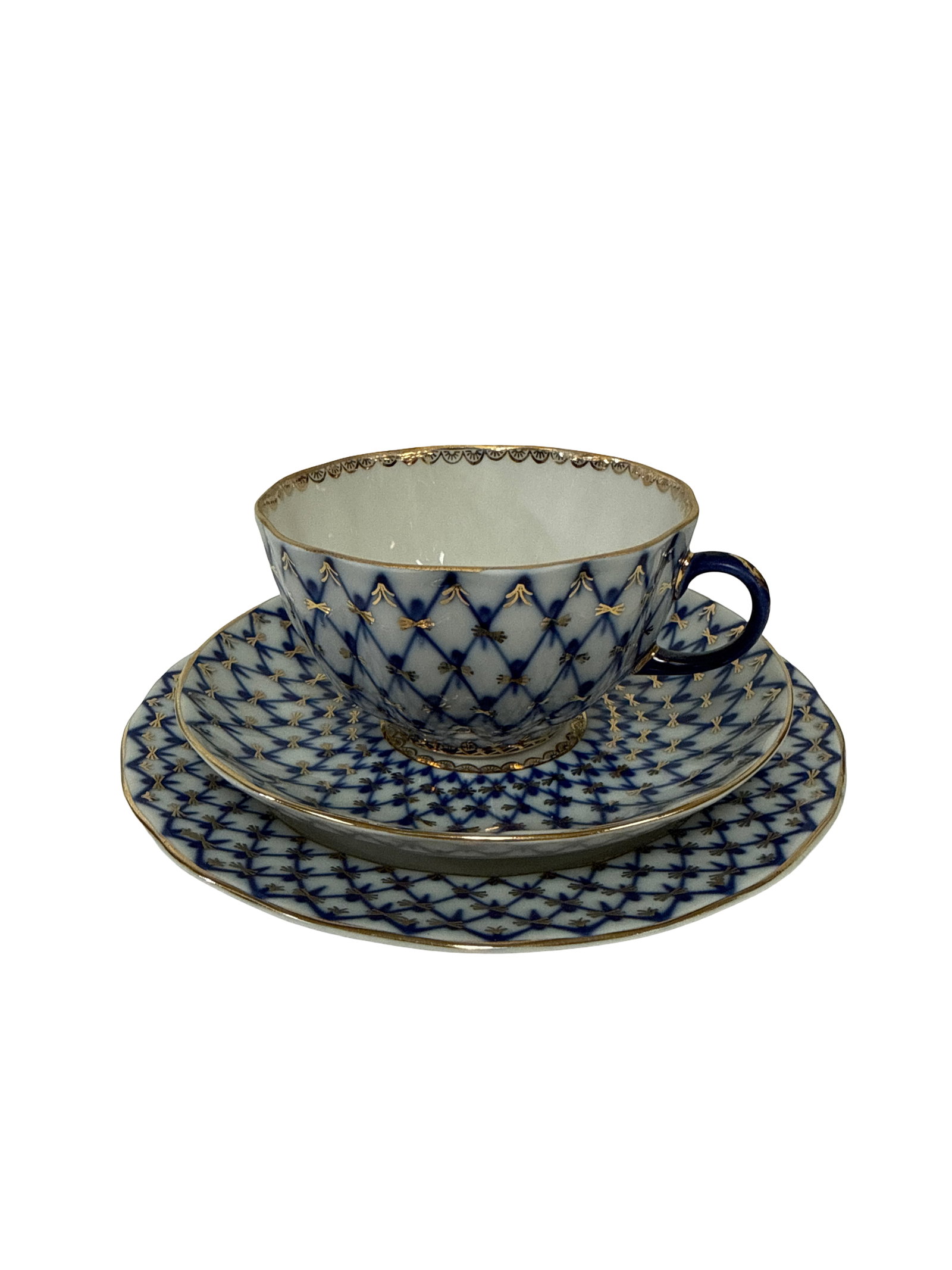 Lomonosov Style Cobalt Net Tea Trio: This three-piece porcelain set features the iconic 'Cobalt Net' pattern, characterized by an intricate hand-painted blue lattice and gold accents. The lot includes a teacup, a matching saucer, and a