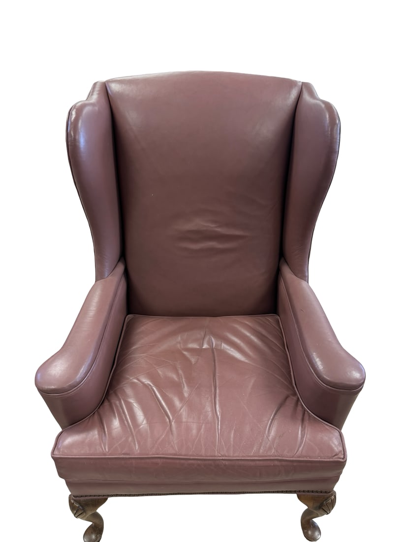 Ethan Allen Leather Wingback Chair: A classic wingback armchair by Ethan Allen upholstered in a mauve-tone top-grain leather. The chair features elegant nailhead trim detailing along the wings and base, supported by carved wood cabriole