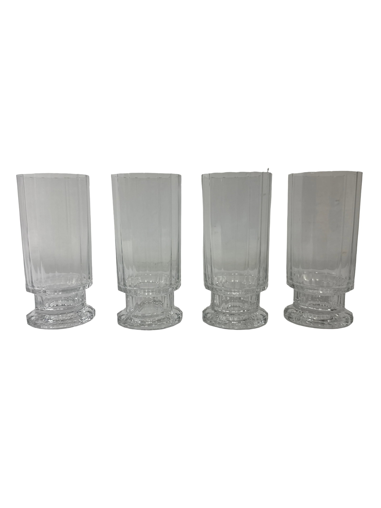 Set of 4 Paneled Crystal Highballs: A set of four elegant crystal highball glasses featuring a classic paneled design and footed bases. Each glass displays sharp vertical facets that catch the light beautifully, typical of high-quality 