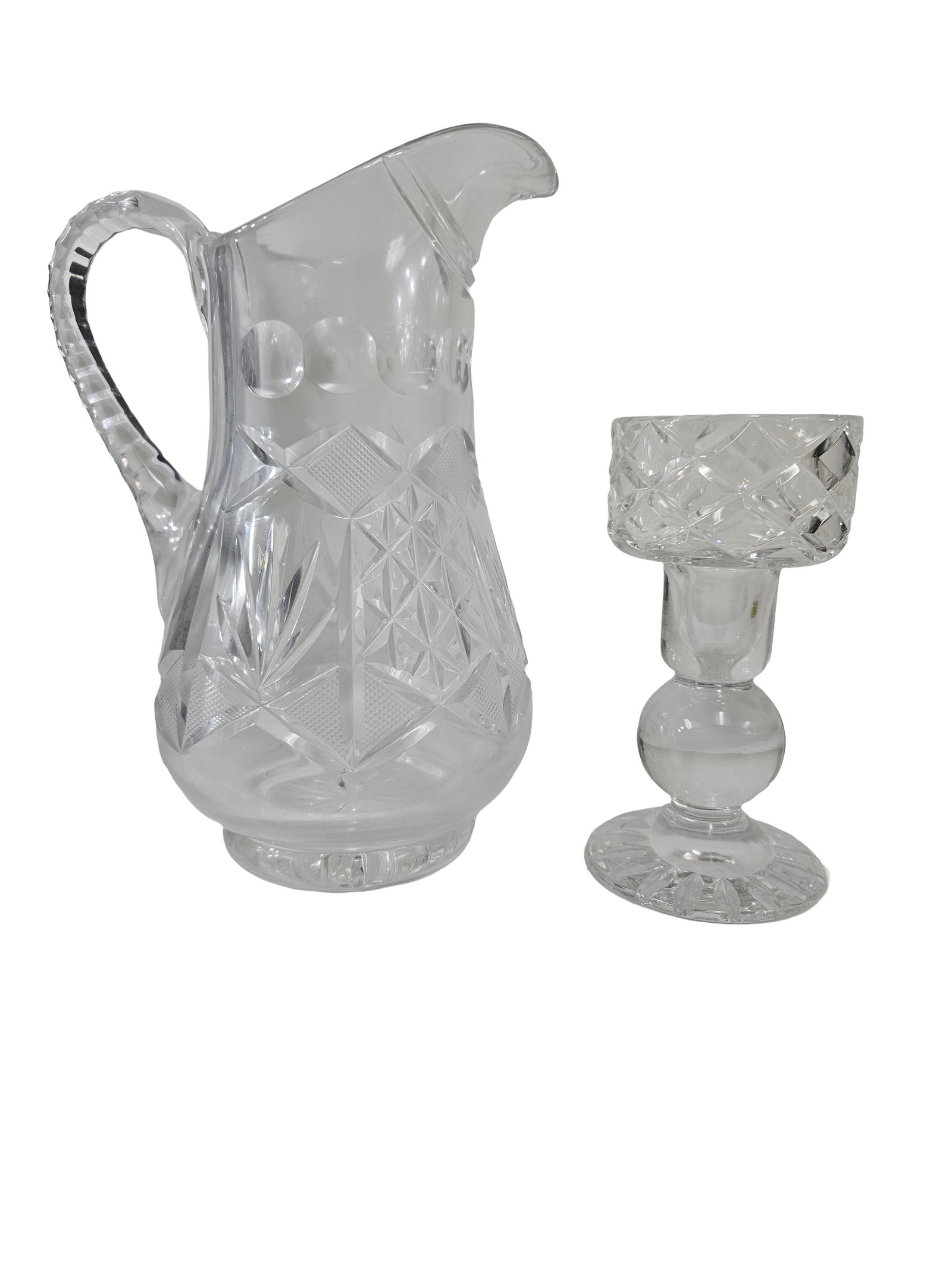 Vintage Cut Glass Pitcher & Candlestick: This two-piece lot features a vintage cut glass water pitcher paired with a matching crystal candlestick holder. Both pieces display intricate diamond and starburst cut patterns that provide brilliant