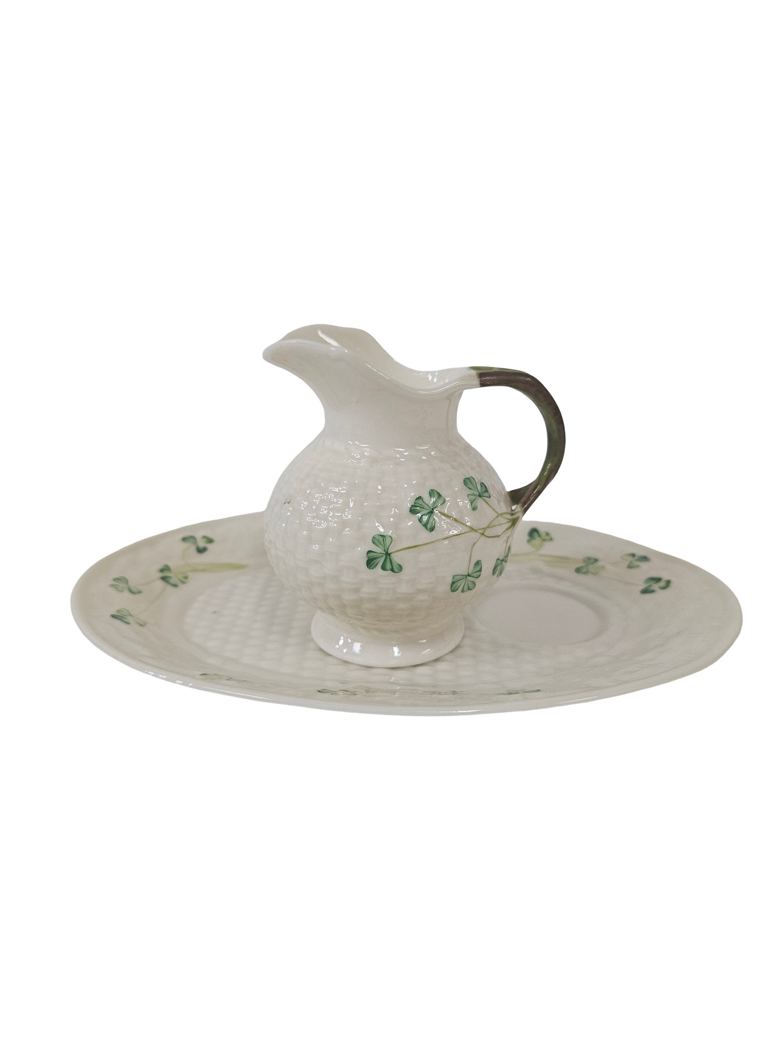 Irish Style Shamrock Pitcher and Tray: This two-piece porcelain set features a small pitcher and a coordinating oval tray, both decorated in a traditional shamrock pattern. The pieces showcase a classic basketweave texture and are