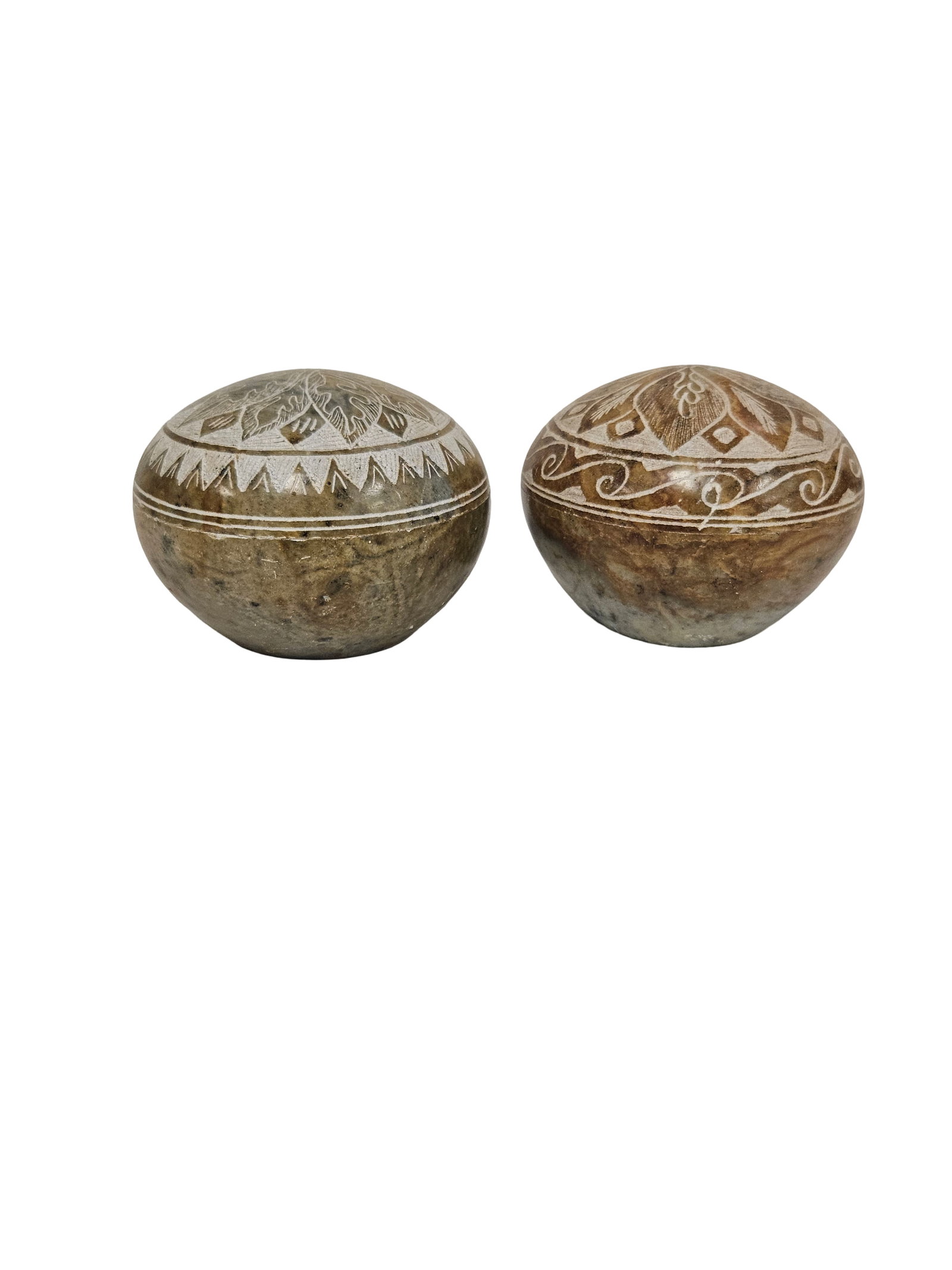 Pair of Hand-Carved Soapstone Boxes: This lot features two hand-carved soapstone trinket boxes with matching dome lids. Each vessel displays intricate sgraffito-style floral and geometric etchings on the upper half, contrasted against a