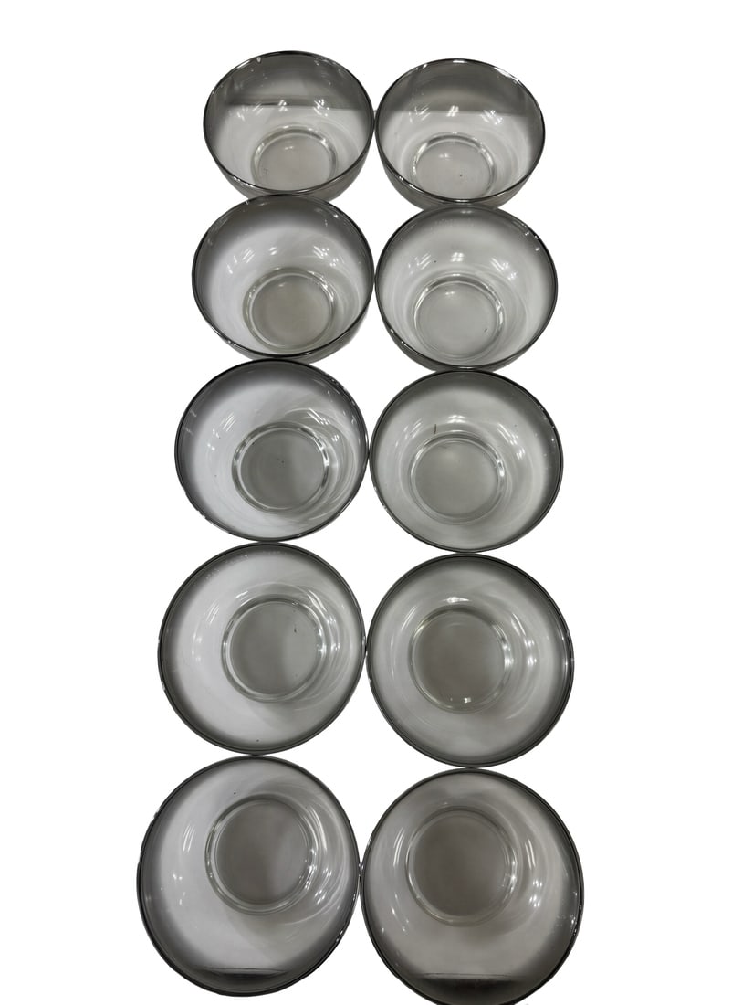10 Vintage Smoky Grey Silver Rim Bowls: This collection features ten vintage glass bowls finished with a sleek smoky grey gradient and metallic silver-toned rims. The mid-century modern aesthetic is highlighted by the translucent tinted gla