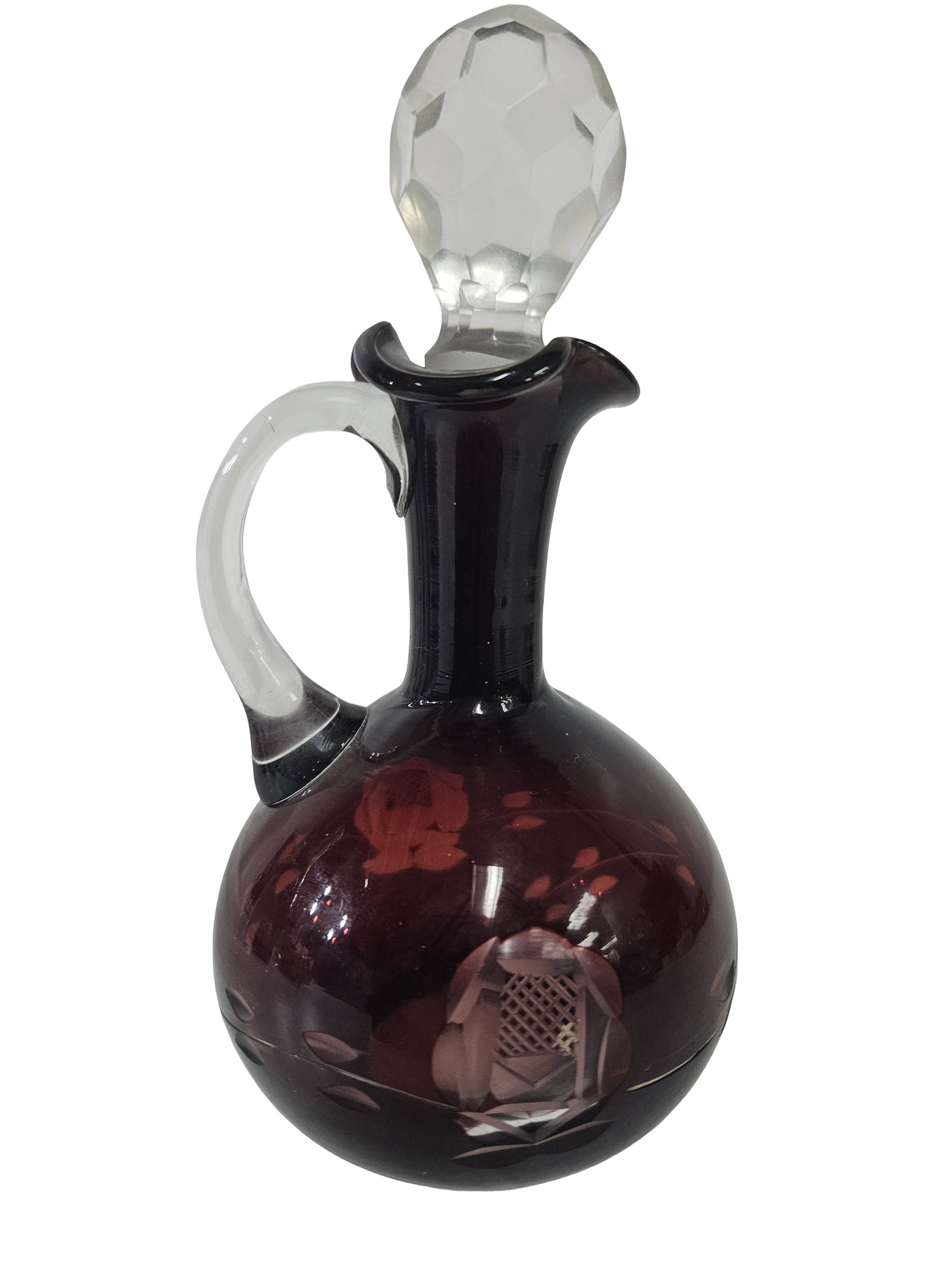 Amethyst Cut-to-Clear Glass Cruet: This elegant hand-blown cruet is crafted from deep amethyst glass with a contrasting clear applied handle and a faceted crystal stopper. The body features intricate cut-to-clear floral motifs, showcas