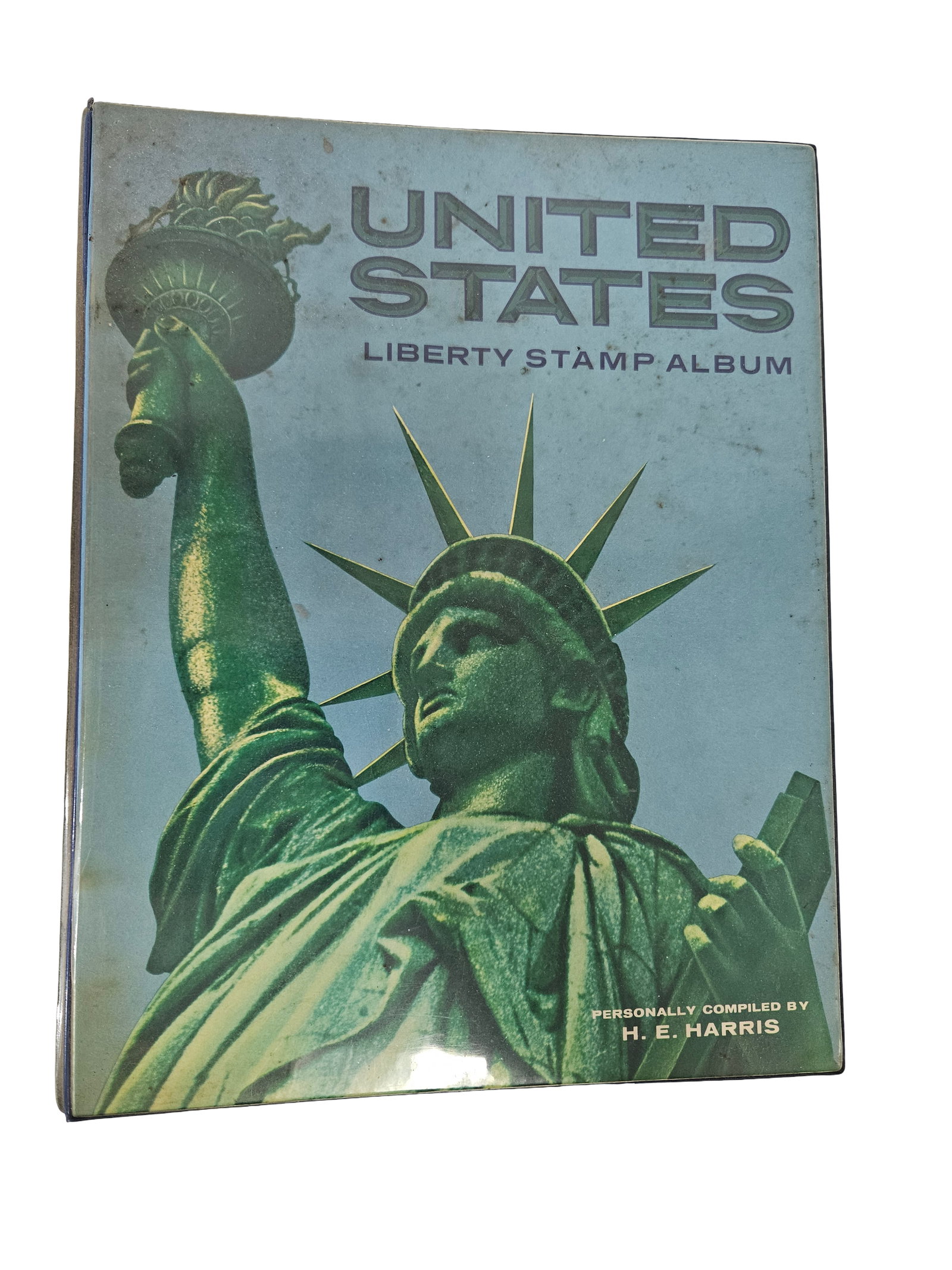 H.E. Harris United States Stamp Album: This H. E. Harris & Co. United States Liberty Stamp Album features a copyright date of 1968 and is housed in a blue three-ring binder. The album includes illustrated pages for various U.S. regular