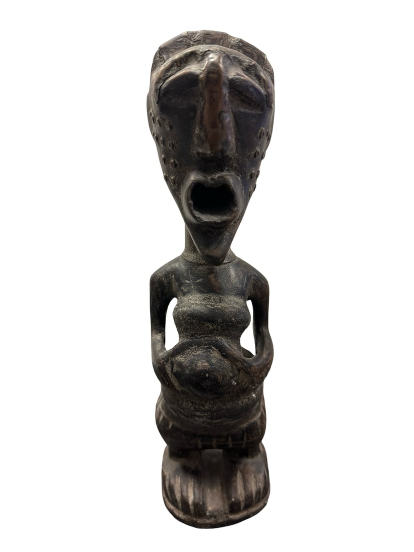 African Style Hand-Carved Wood Figure: This hand-carved wood figure features an elongated face with an open mouth and distinctive scarification markings. The female form is depicted with arms resting on her abdomen and stylized clothing de