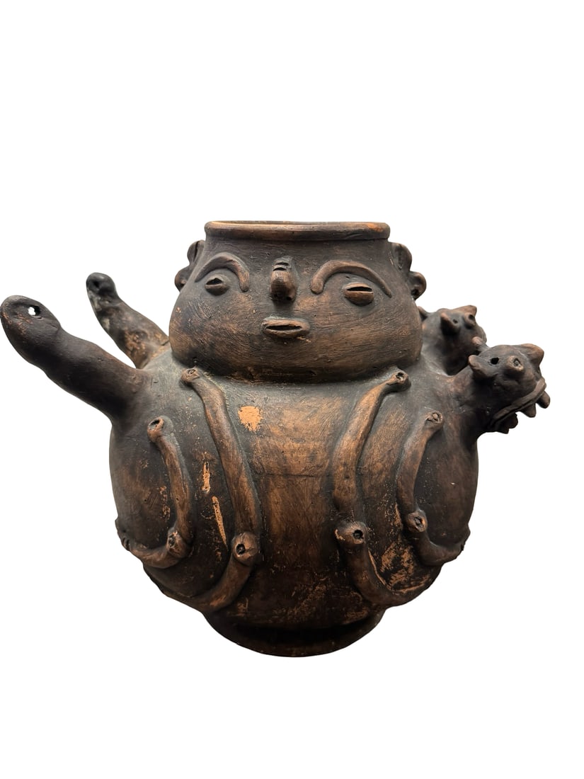 Pre-Columbian Style Terracotta Effigy: This large hand-built terracotta vessel features a globular body decorated with a variety of anthropomorphic and zoomorphic relief motifs. The central figure displays a stylized face with coffee-bean 