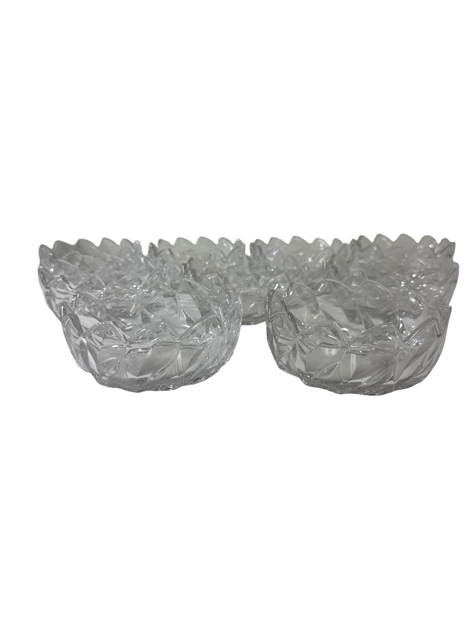 Set of 8 Scalloped Cut Glass Bowls: This lot features a set of eight matching clear glass fruit or dessert bowls. Each bowl displays a deep faceted diamond pattern with a decorative scalloped rim resembling a lotus flower. The heavy