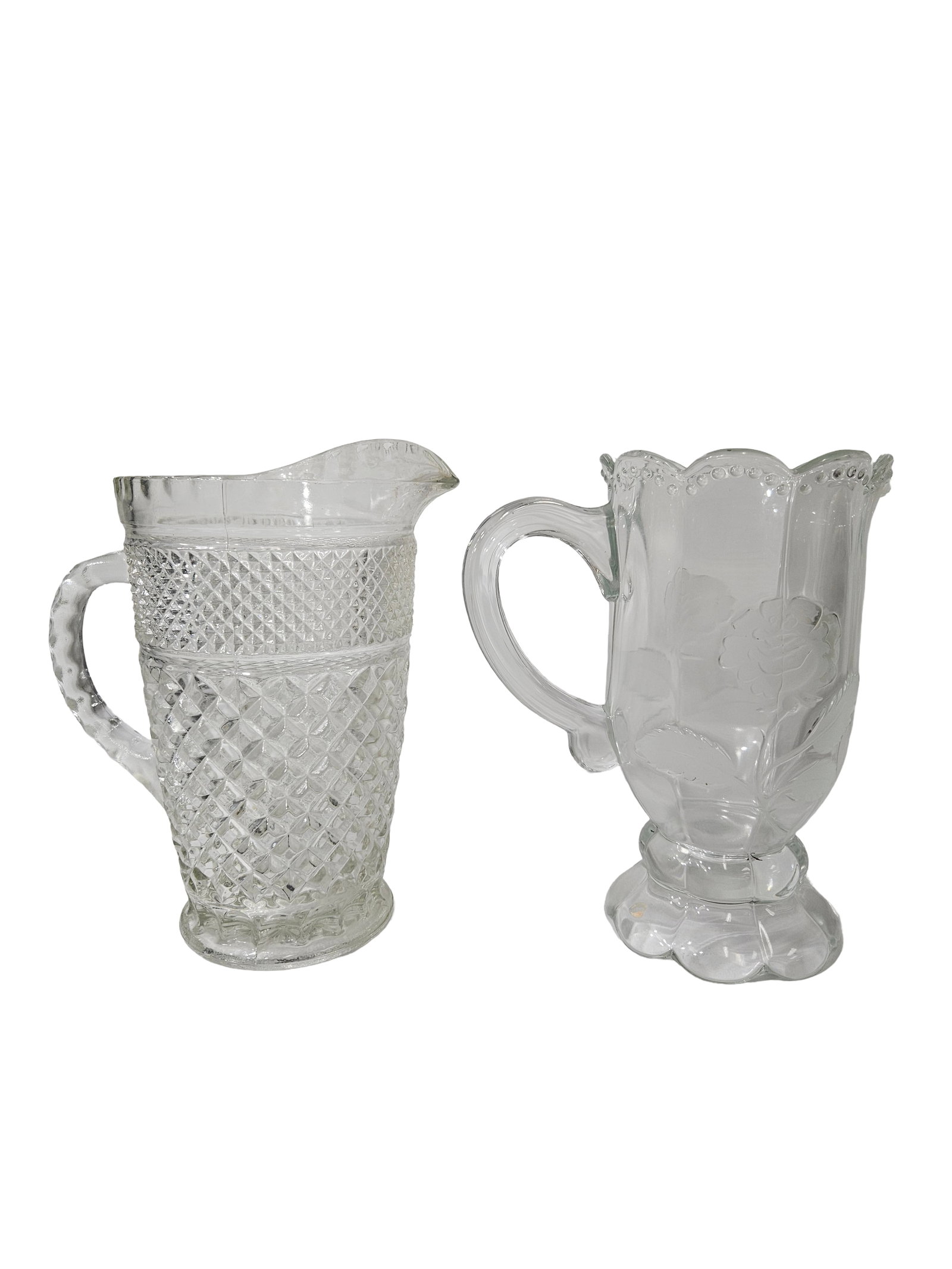 Two Vintage Clear Textured Glass: This lot features two vintage clear glass pitchers with distinct decorative styles. One pitcher displays a classic diamond-cut hobnail pattern, while the other features an elegant frosted rose motif