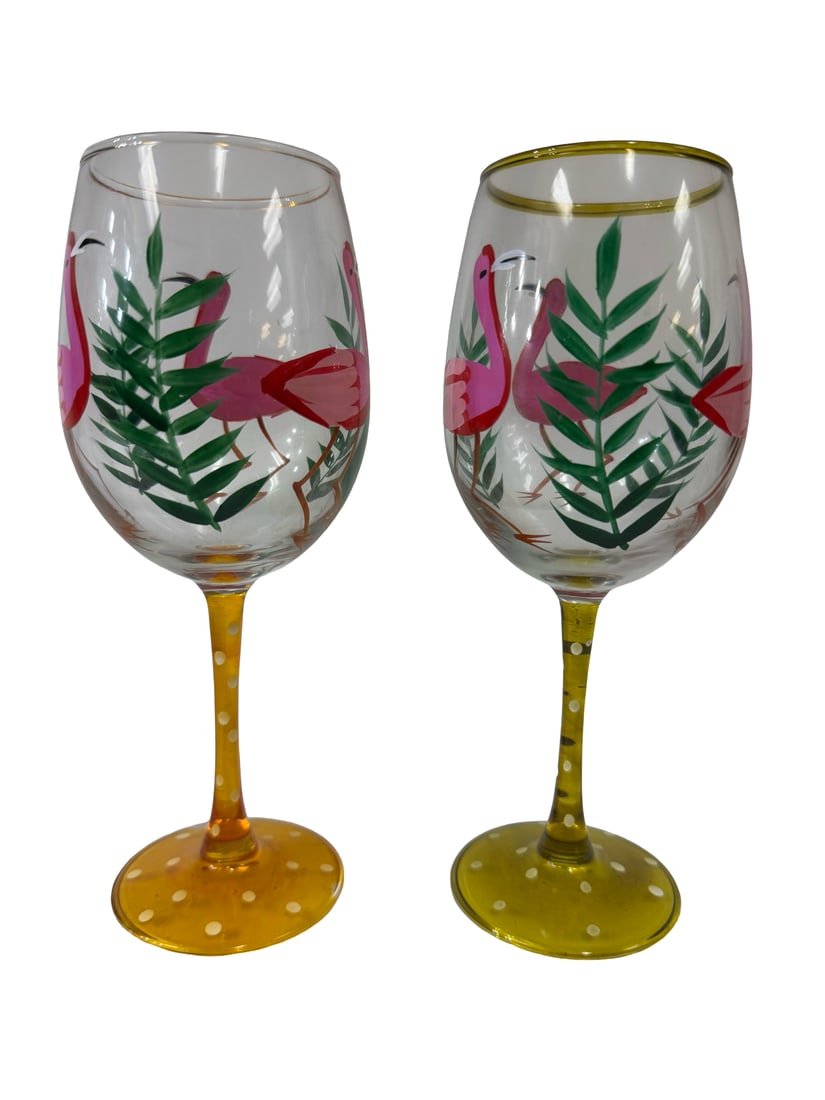 Pair of Hand-Painted Flamingo Glasses: This pair of hand-painted wine glasses features a vibrant tropical motif with pink flamingos and green palm fronds. Each glass is uniquely detailed with a polka-dot stem and base in coordinating