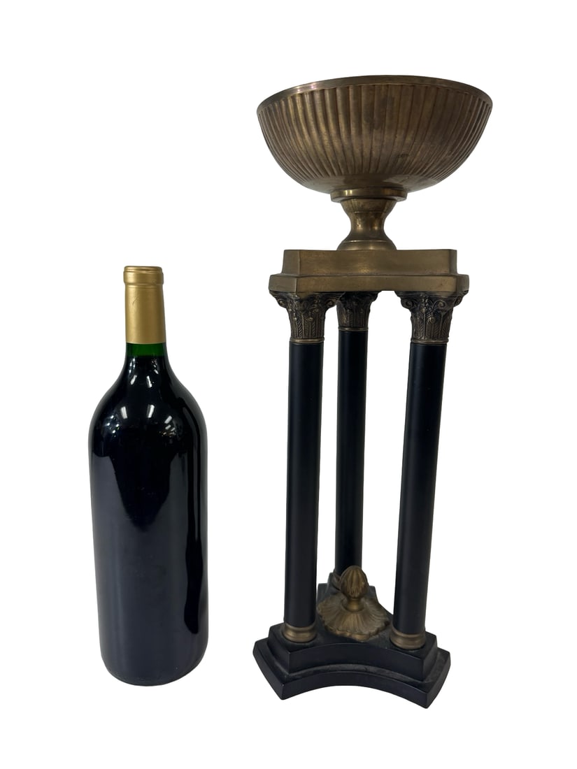 Neoclassical Style Brass Column Tazza: This Neoclassical-inspired centerpiece features a fluted brass bowl supported by a tripod stand of three black columns with ornate Corinthian capitals. The architectural base rests on a concave