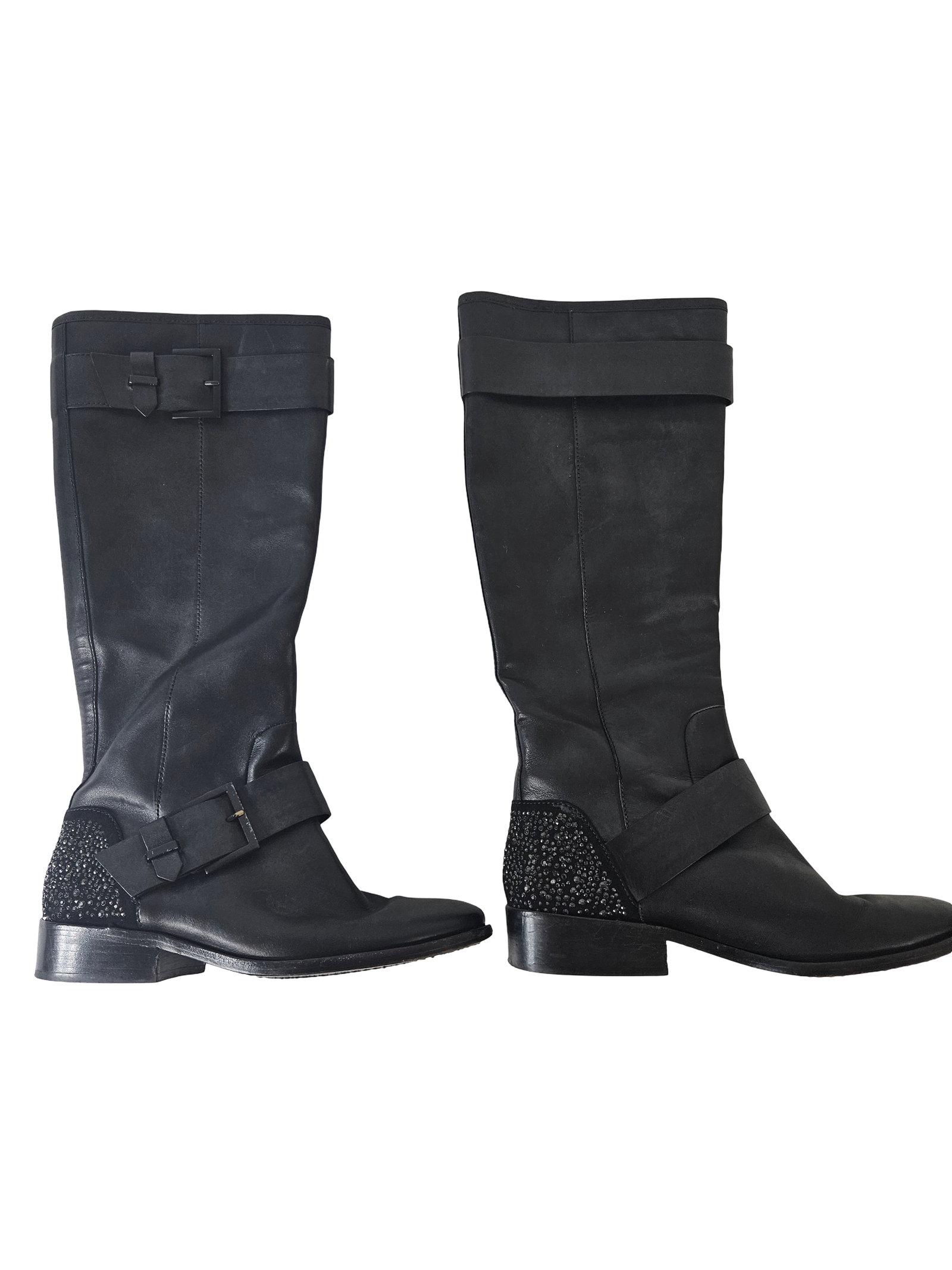 Brian Atwood Crystal Studded Boots 7.5: These Brian Atwood leather boots feature a knee-high silhouette with decorative buckle straps at the ankle and top. The heel counters are embellished with tonal black micro-crystals for a subtle