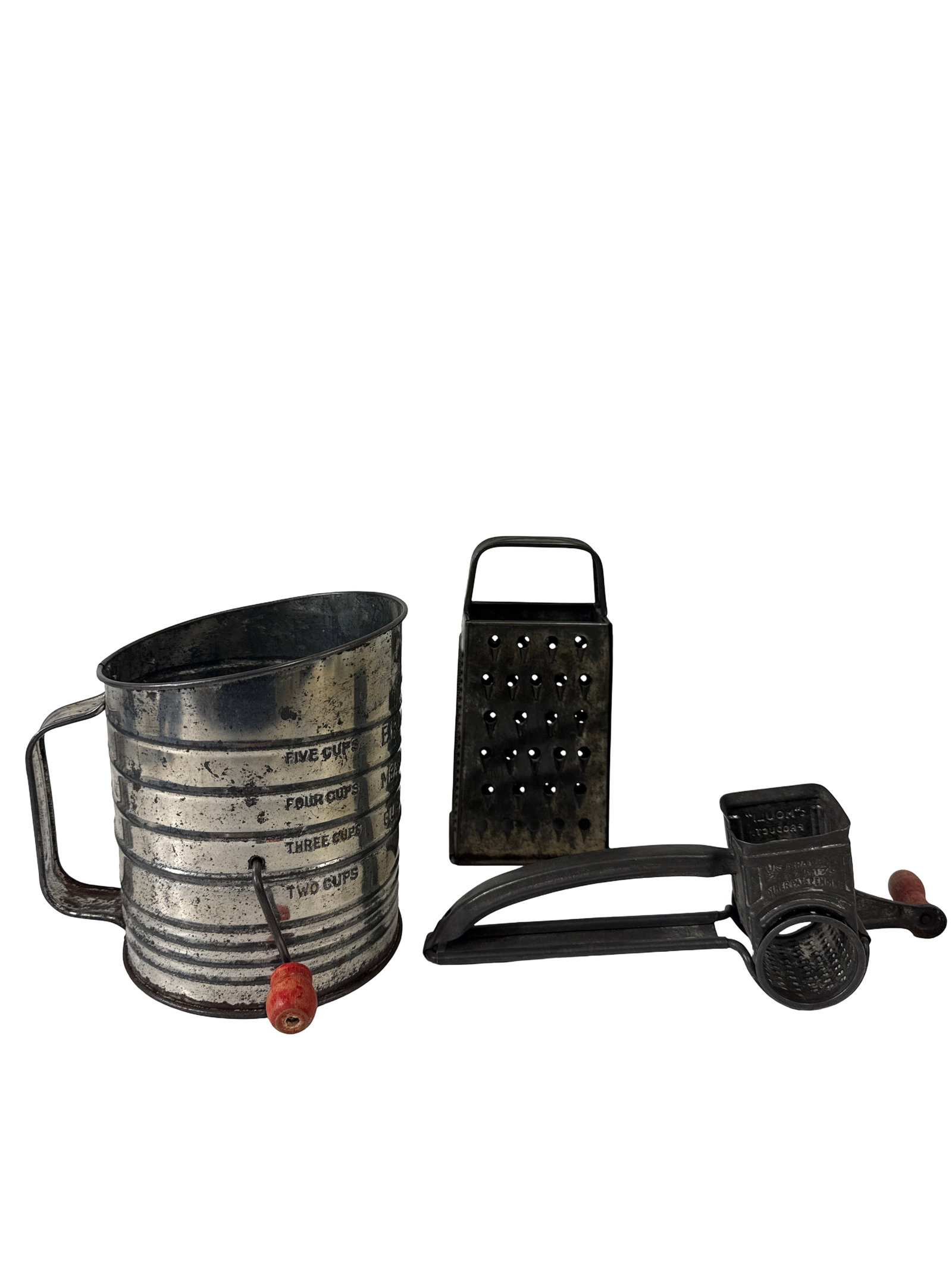 Vintage Bromwell's Sifter and Grater Lot: A three-piece collection of vintage metal kitchenware featuring a Bromwell's Measuring Sifter with a red wooden handle. The lot includes a hand-crank rotary cheese grater and a standard four-sided box