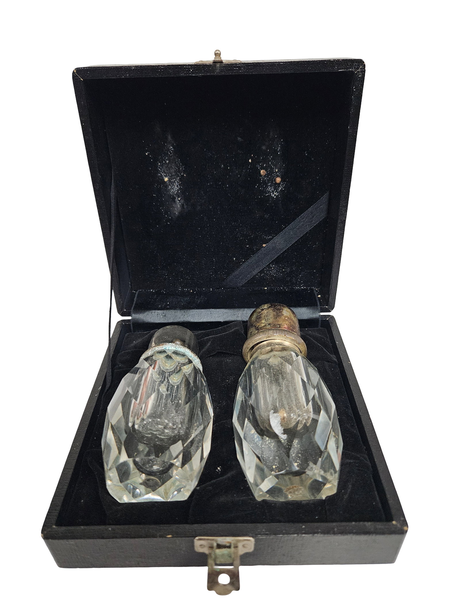 Cased Faceted Cut Glass Shaker Pair: A pair of faceted cut glass shakers housed in a black velvet-lined fitted presentation box. The shakers feature metal caps with decorative beaded and knurled rims, showing a heavy patina consistent