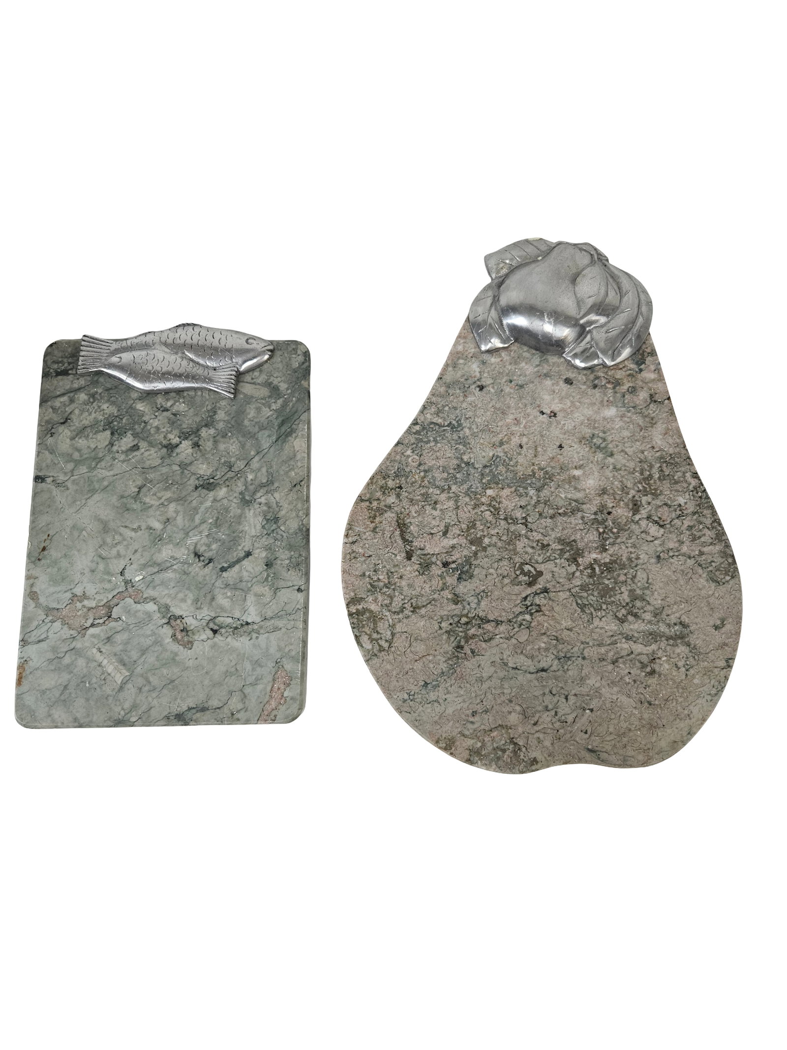 Two Marble Serving Boards with Accents: This pair of decorative serving boards features a pear-shaped pink marble board with a leaf-wrapped fruit metal accent and a rectangular green marble board with a fish-themed metal clip. The marble